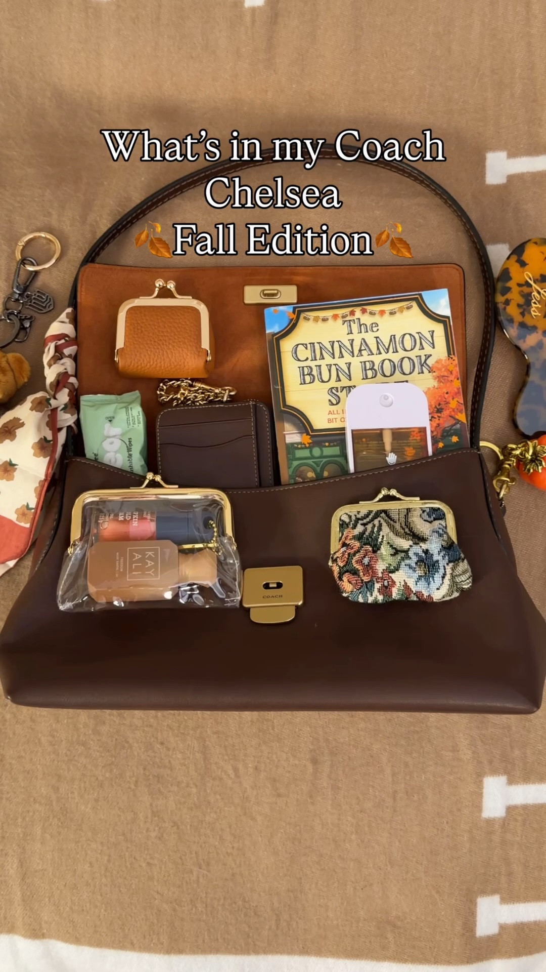 Packing my Coach Chelsea for fall 🍂 Comment SHOP & I’ll dm you the links 🍁

What’s in my bag:
Coach Chelsea 30 in maple 
Chelsea bag insert
Cinnamon bun book store book 
Clear kisslock pouch
KayAli mini perfume
Bath and body works pumpkin cold foam lip oil with pumpkin charm
Coach outlet wallet
Vintage Kisslock pouch from Etsy
Rare guests mini blush
Tom ford mini lipstick
Touchland hand sanitizer
Mini jewelry pouch 
Customized hair brush 
Pumpkin bag charm from Amazon
Islander uk bear charm