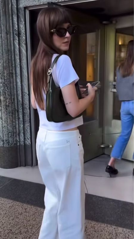 Shop Dakota Johnson's white high waist wide leg jeans, short sleeve white T-shirt, leather shoulder bag, cat eye sunglasses #DakotaJohnson #CelebrityStyle

#LTKStyleTip