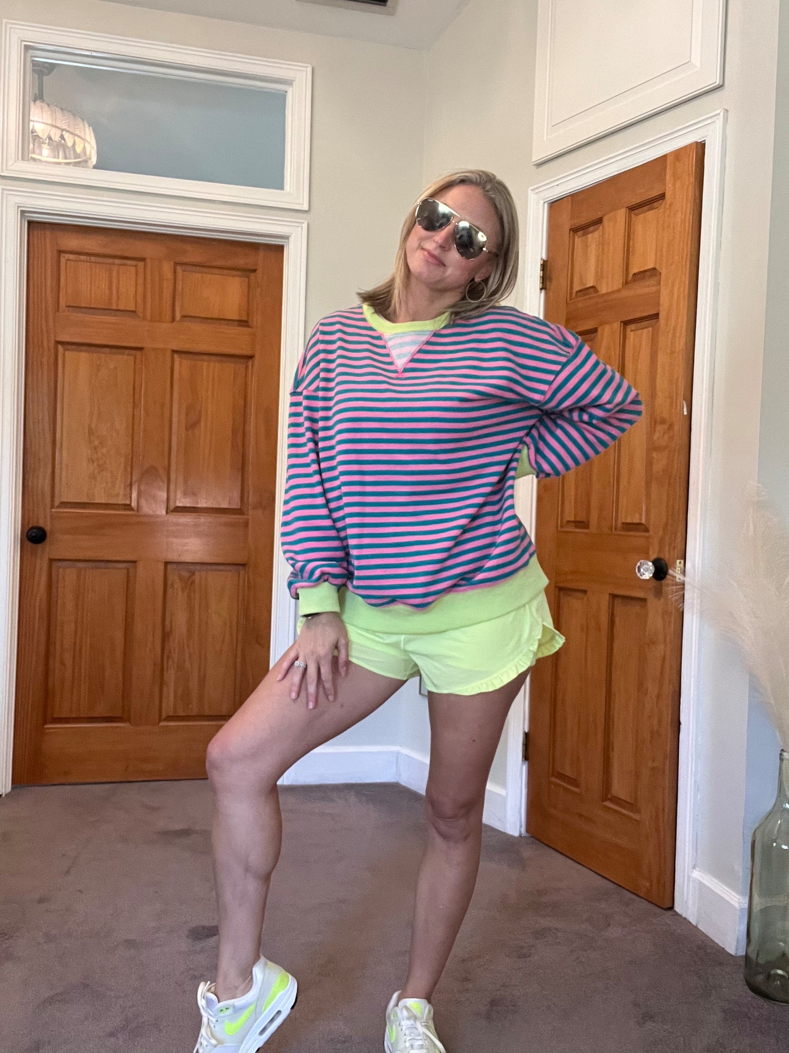 My most favorite sweatshirt of all time! Looks like a more expensive version, just as good quality. I am obsessed with this color combo for the spring and summer. I also HAD to grab these aerie ruffled shorts…they match the sweatshirt and my Nikes perfectly. Wearing size medium in everything. Size up in sweatshirt if you want it even baggier. 

#LTKOver40 #LTKootd #LTKActive
