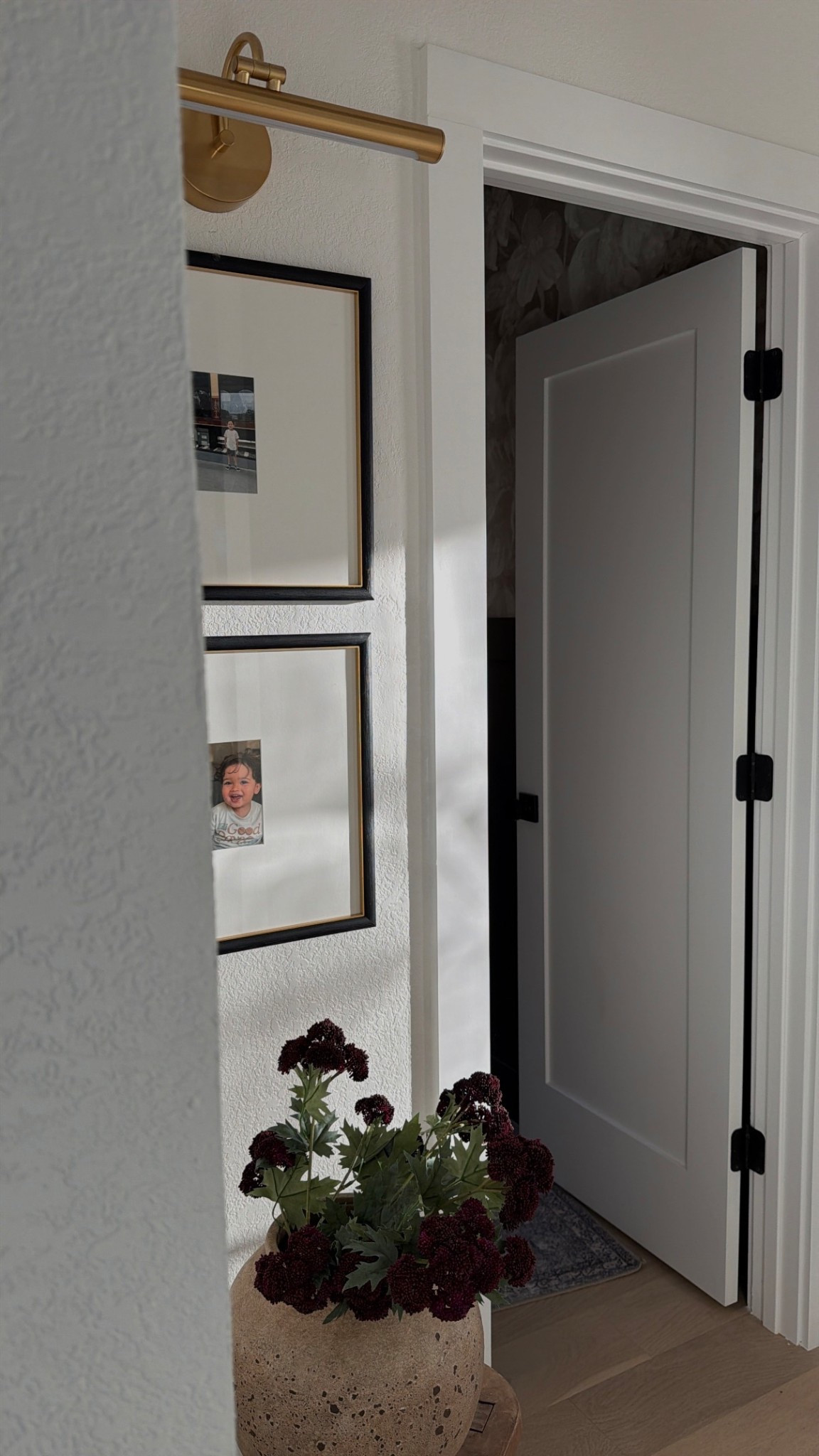 My favorite little hall corner essentials! Stems are Hobby Lobby 🤎

Picture light, matted frame, target stool, gallery frames 

#LTKHome