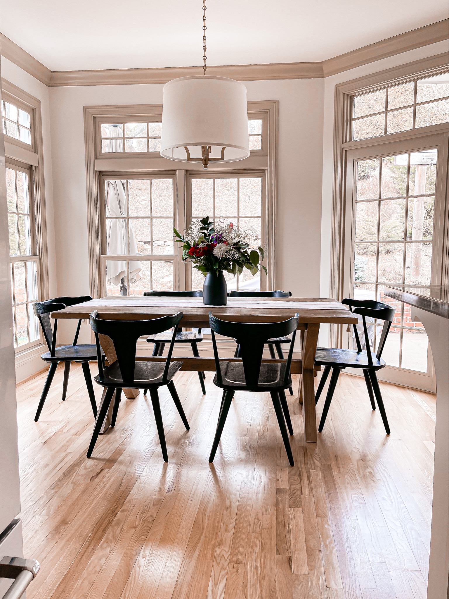Our breakfast nook in the winter. Simple table decor. Black vase with flowers and table runner. 

#LTKhome #LTKSeasonal #LTKfamily