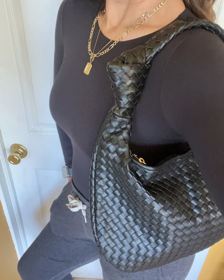 I absolutely love this Bottega Veneta dupe! You don’t have to spend a lot of money (read: thousands for the real deal) to look chic and stylish. This is a good one I’ve had my eye on for months and I finally own it! It comes in multiple colors and pretty light colors for Spring and Summer. You can’t ever go wrong though with a good black handbag IMO. Accessories, luxe for less, designer dupe, designer inspired style, mom style, #LaidbackLuxeLife

Bodysuit: S
Joggers: S Long

Follow me for more fashion finds, beauty faves, lifestyle, home decor, sales and more! So glad you’re here!! XO, Karma

#LTKStyleTip #LTKItBag
