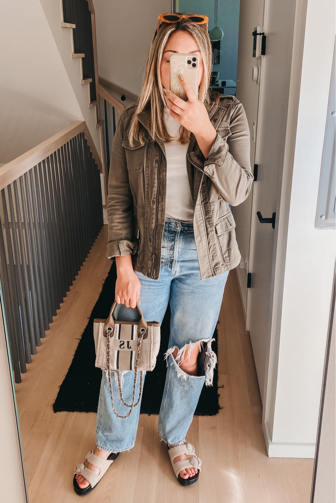 Olive green military jacket. Ribbed tee. Relaxed 90s jeans. Shearling slide sandals. Monogrammed mini bag.

#LTKSeasonal