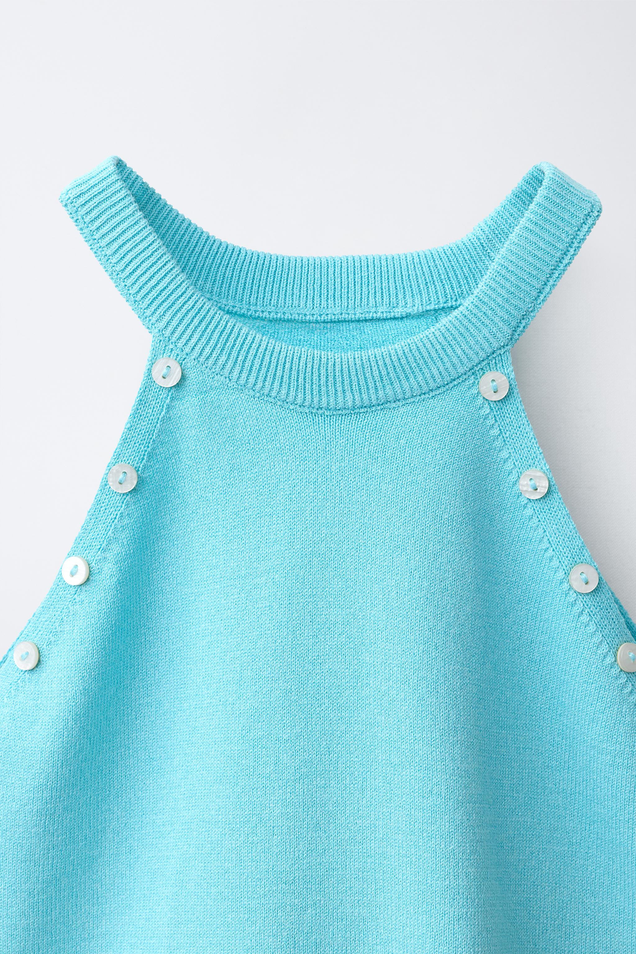Sleeveless knit top with a halter neckline. Featuring decorative buttons on the front. | Zara UK