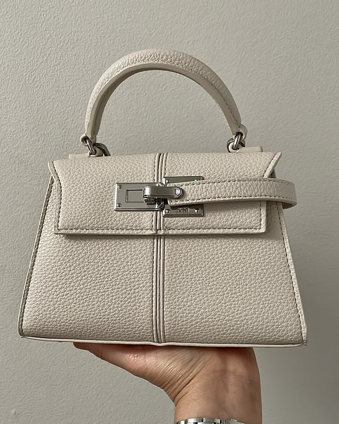 This is another JW Pei mini bag that I ordered in the off white color. The vegan leather is soft and it looks well made. The style is similar to a high end designer bag (Hermes mini Kelly) and it's under $100. 

The white has a grey cast to it so I wish it was a true white. It's also available in more colors and in a larger size. The bag comes with a removable and adjustable crossbody bag.

It doesn't fit as much as the other black bag I just posted but if you're a minimalist then that may not be an issue.

Nordstrom carries some JW Pei styles like this mini Elise bag so I linked to them as well.

#LTKFindsUnder100 #LTKOver40 #LTKItBag