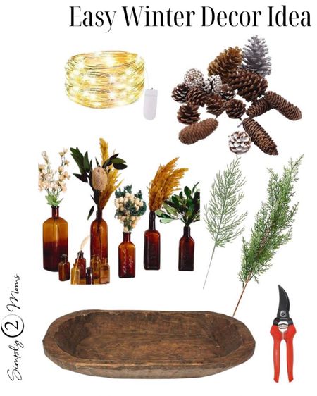 Make an easy winter home decor piece in minutes. A wood dough bowl or any tray filled with amber glass bottles. Then add fresh or faux evergreen stems. Surround bottles in bowl with pinecones and add a string of twinkle lights for a simple affordable winter centerpiece. #winterhomedecorating #tablescapes #centerpieces 

#LTKFind #LTKSeasonal #LTKhome