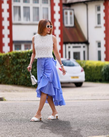 Diva Full Lace Crop Sleeveless Top in White Ruffle Tiered Frill Hem Skirt in Blue Stripes White Mules White Mini Bag White Sunglasses Spring Outfit Everyday Outfit Summer Outfit Smart Casual Look

#LTKstyletip #LTKeurope #LTKover40
