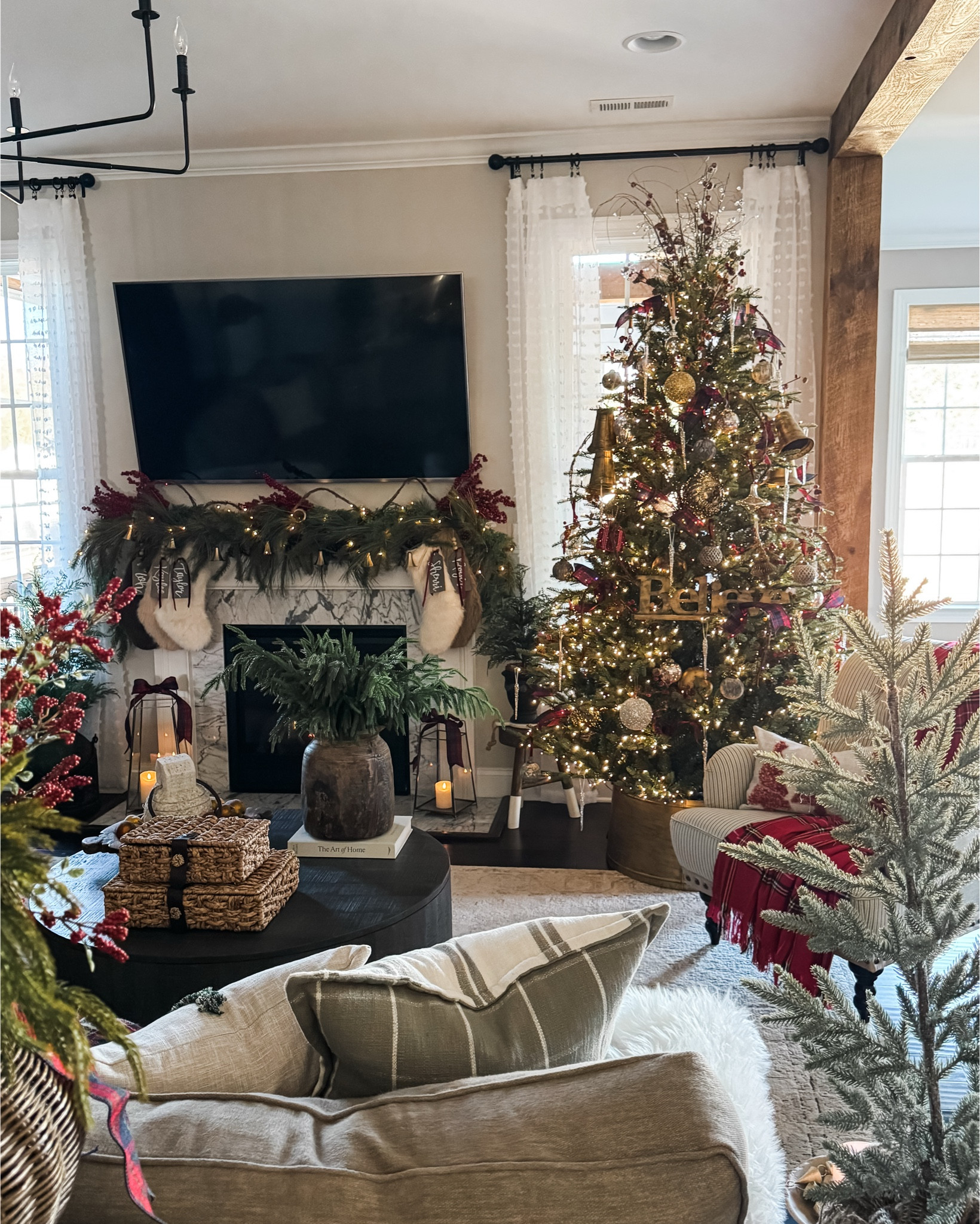 
Christmas in my living room. This is the 7.5' Grand Duchess. It is stunning!! The gold tree collar was a DIY. I have linked some similar options.

Christmas tree, tree collar, ornaments, velvet ribbon, grapevine garland, bell garland, gold bells, , chandelier, vase, vintage inspired ornaments, floor lamp, berry stems, Christmas pillow cover, plaid throw, upholstered side chair, faux fur stockings, name tags, Norfolk pine stems, cedar stems, garland, rattan storage boxes 



#LTKHoliday #LTKSeasonal #LTKHome