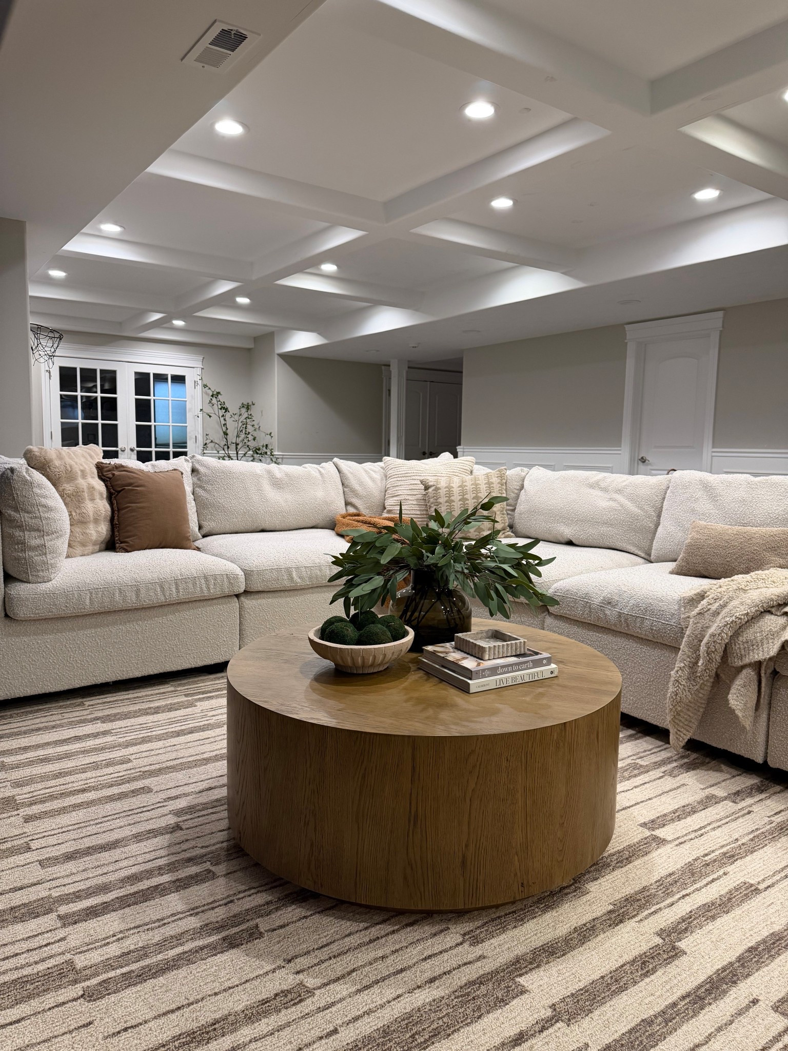 A closer look at our basement family room 🤍

This oversized sectional is one of our favorite pieces in the house — cozy, durable, and perfect for movie nights with the kids. I layered warm wood tones, texture, and neutral pillows to keep the space feeling calm and inviting.

Linking the sectional, coffee table, rug, and styling pieces here.

#LTKHome