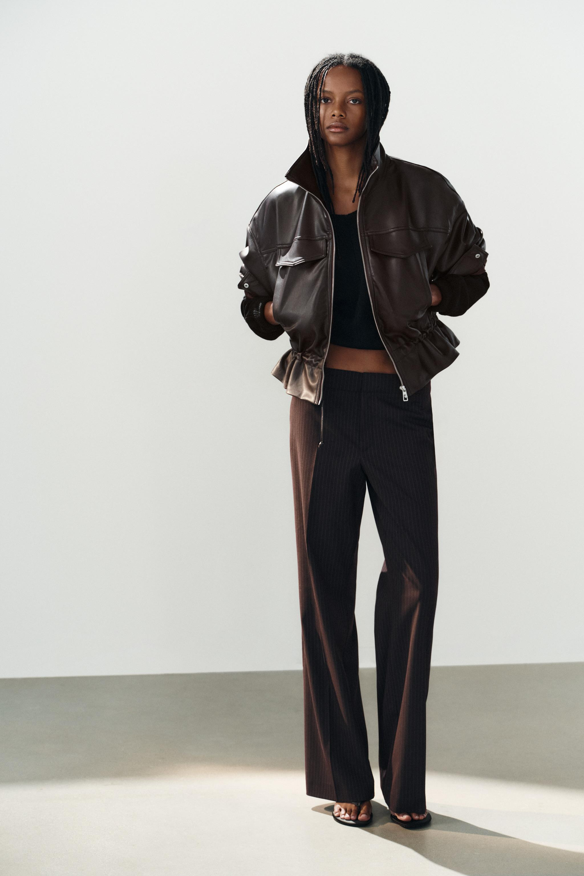 High-neck jacket with long drop-shoulder sleeves. Adjustable waist with drawstrings. Welt pockets... | Zara US