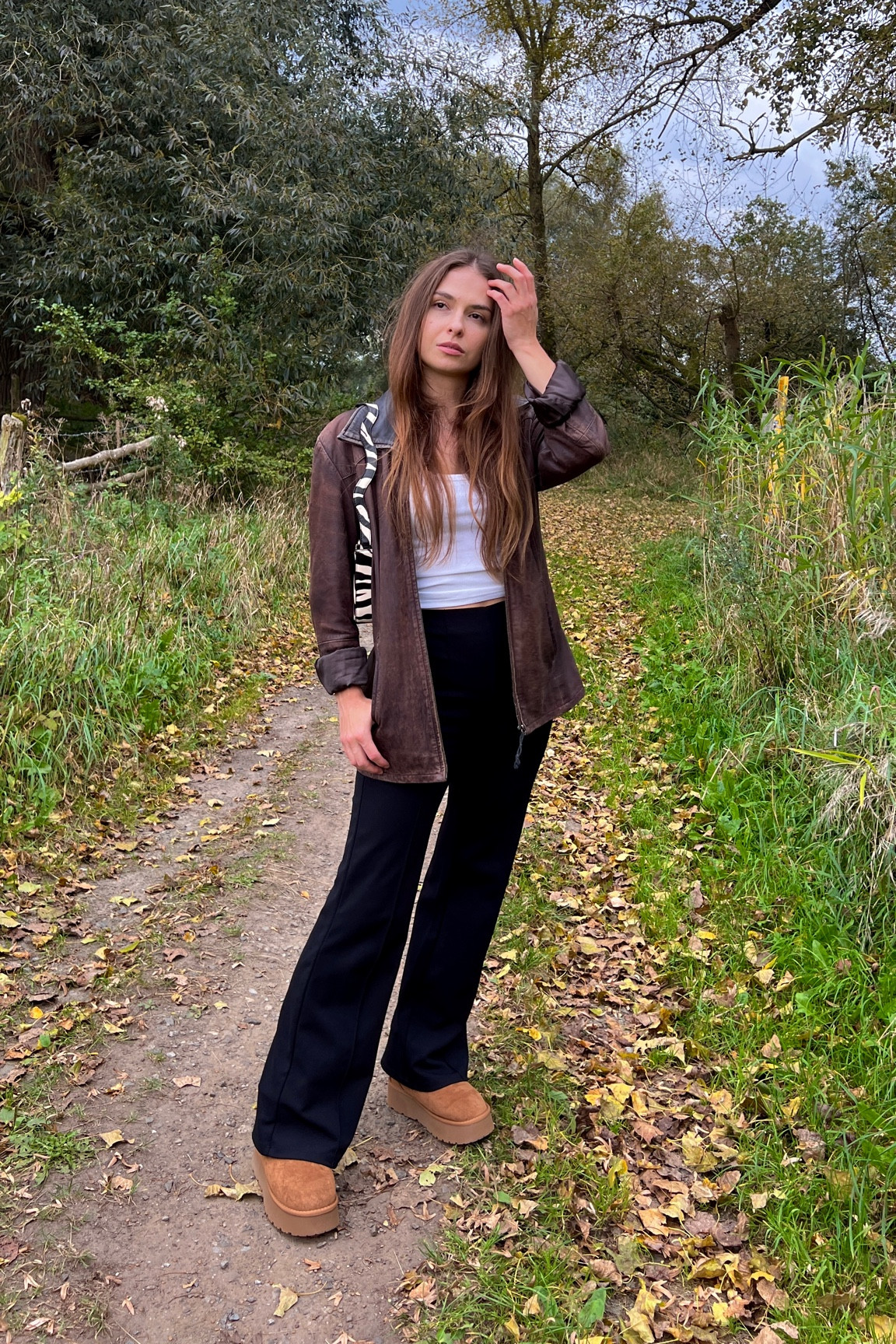 Fall outfit inspo, styling a brown vintage leather jacket, a white knitted top, black pants, a zebra printed bag and UGG dupes. 

#LTKstyletip #LTKSeasonal #LTKfindsunder100
