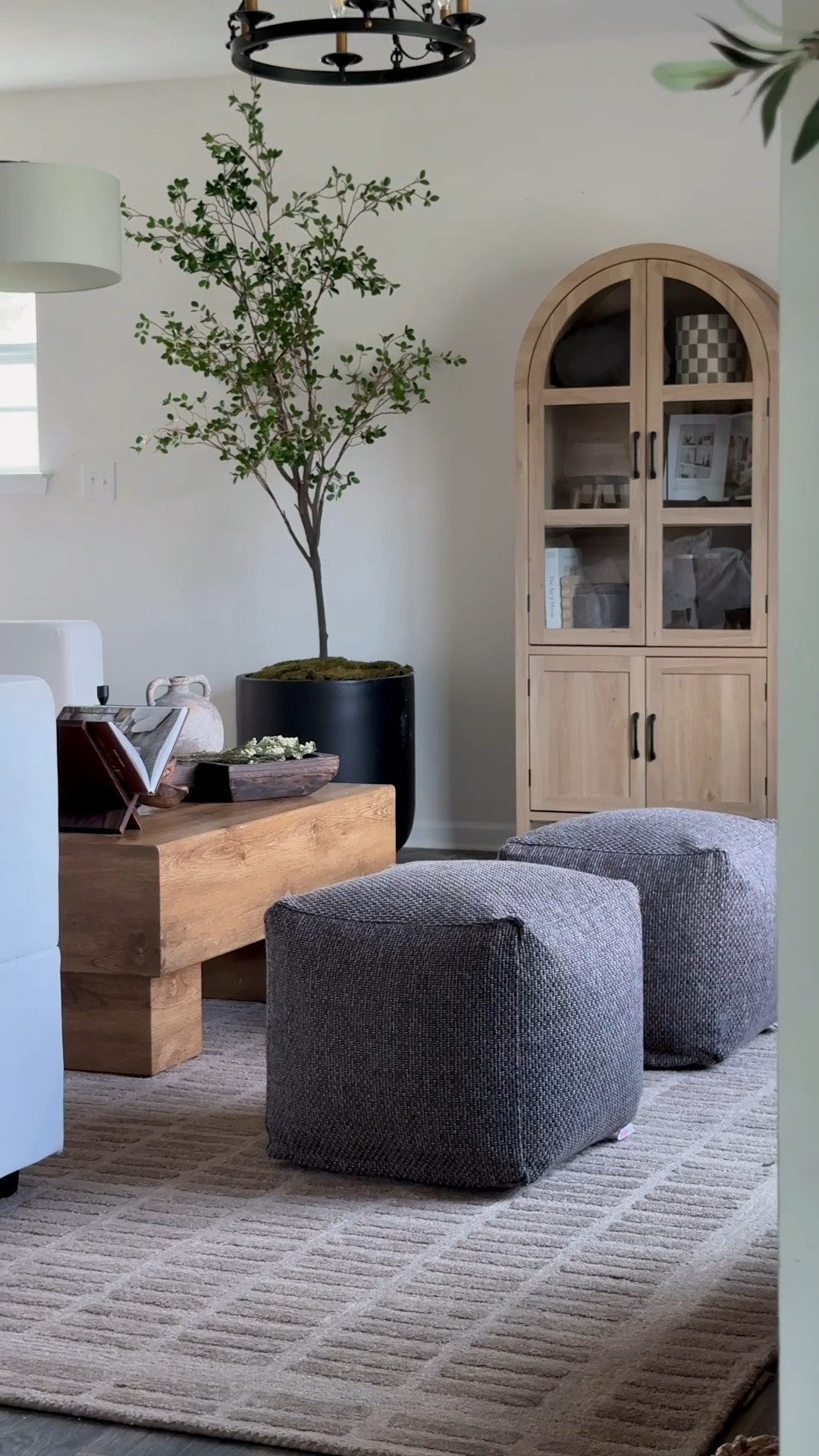 Earthy organic modern living room views with the Loloi Bradley rug in Cocoa 🤎🤌🏼 
Brown wool rug, brown ottomans, oak arch cabinet, 

#LTKSaleAlert #LTKHome