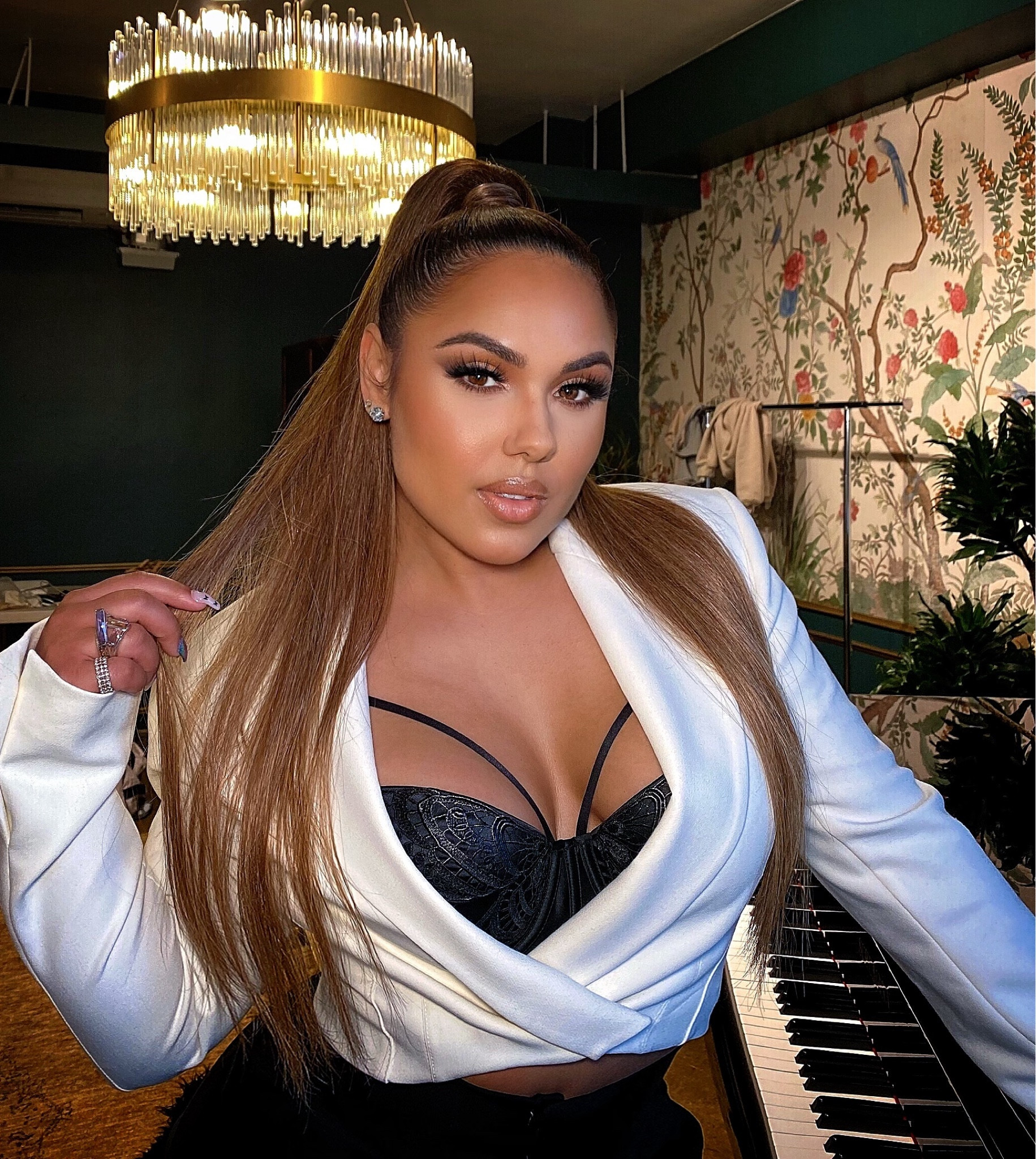 Photo shoot ready rocking a high pony with a white crop top blazer & a black crossover strap corset underneath. #LTKCyberWeek

#LTKHoliday #LTKGiftGuide