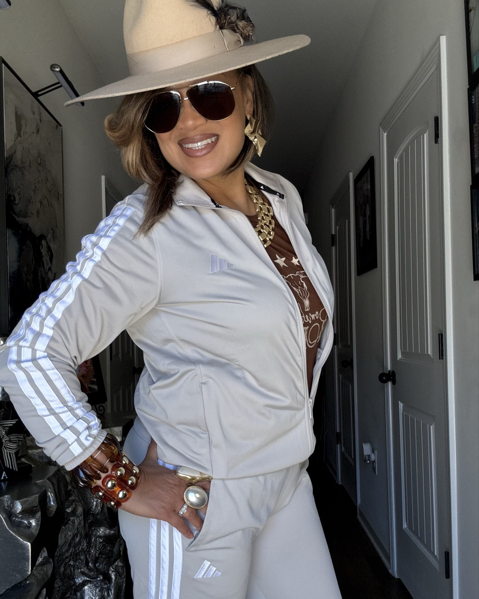 Get into this Adidas taupe tracksuit elevated with a fedora and many accessories!  Turn your tracksuits into a walking billboard by accessorizing it!  #adidas #fedora #jewelry #womenover50 #womenover50fashion #ootd #holiday #tracksuit #edgy #trendy #fall #winter #styleinspo #sunglasses #bracelets #bangles #necklace #rings #earrings #travel #brunch #lunch 

#LTKActive #LTKMidsize #LTKootd