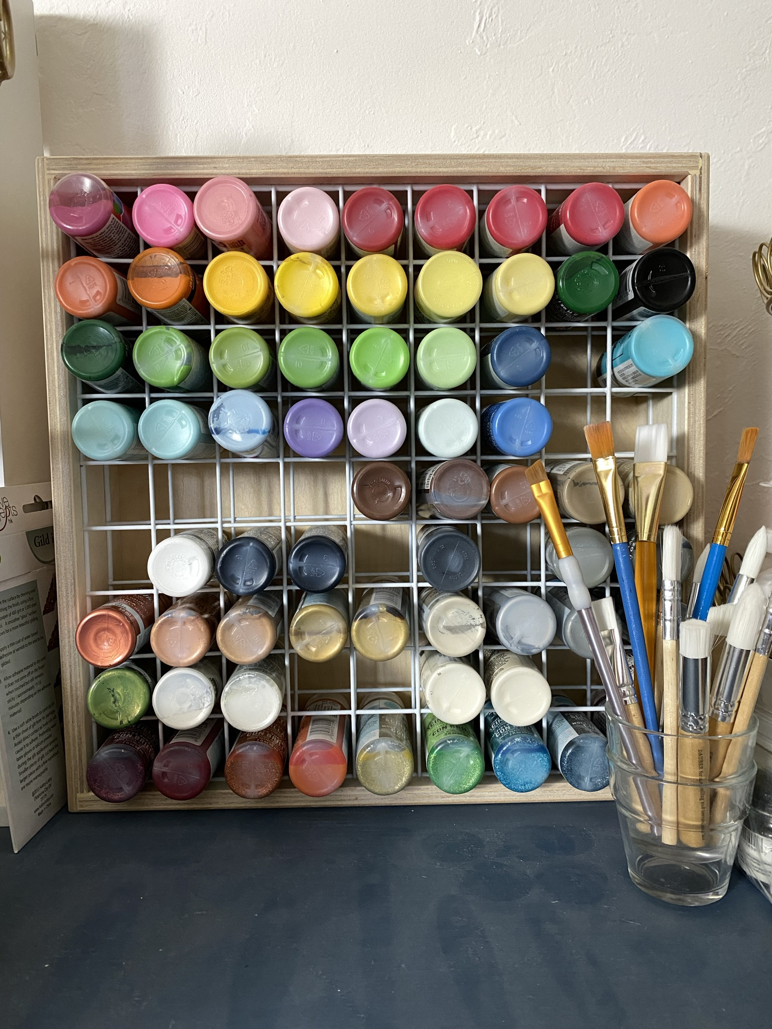 Sharing my craft paint storage rack. I love this thing! It holds 81 bottles of craft acrylic paint (2oz size). The grid comes in 2 colors: white or black. The bottles stay organized and take up less room on my already-limited studio shelf. ✨ For mosaic tips, tutorials, inspiration, and so much more please visit my YouTube channel: YouTube.com/julieweilbacher. ✨ Follow @julieweilbacher on Instagram for all things mosaic art. crafts storage - acrylic paint storage - craft paint storage - paint storage rack - organized creative space - crafter gifts - crafts night in - crafts night - arts and crafts storage

#LTKGiftGuide #LTKfindsunder100 #LTKhome