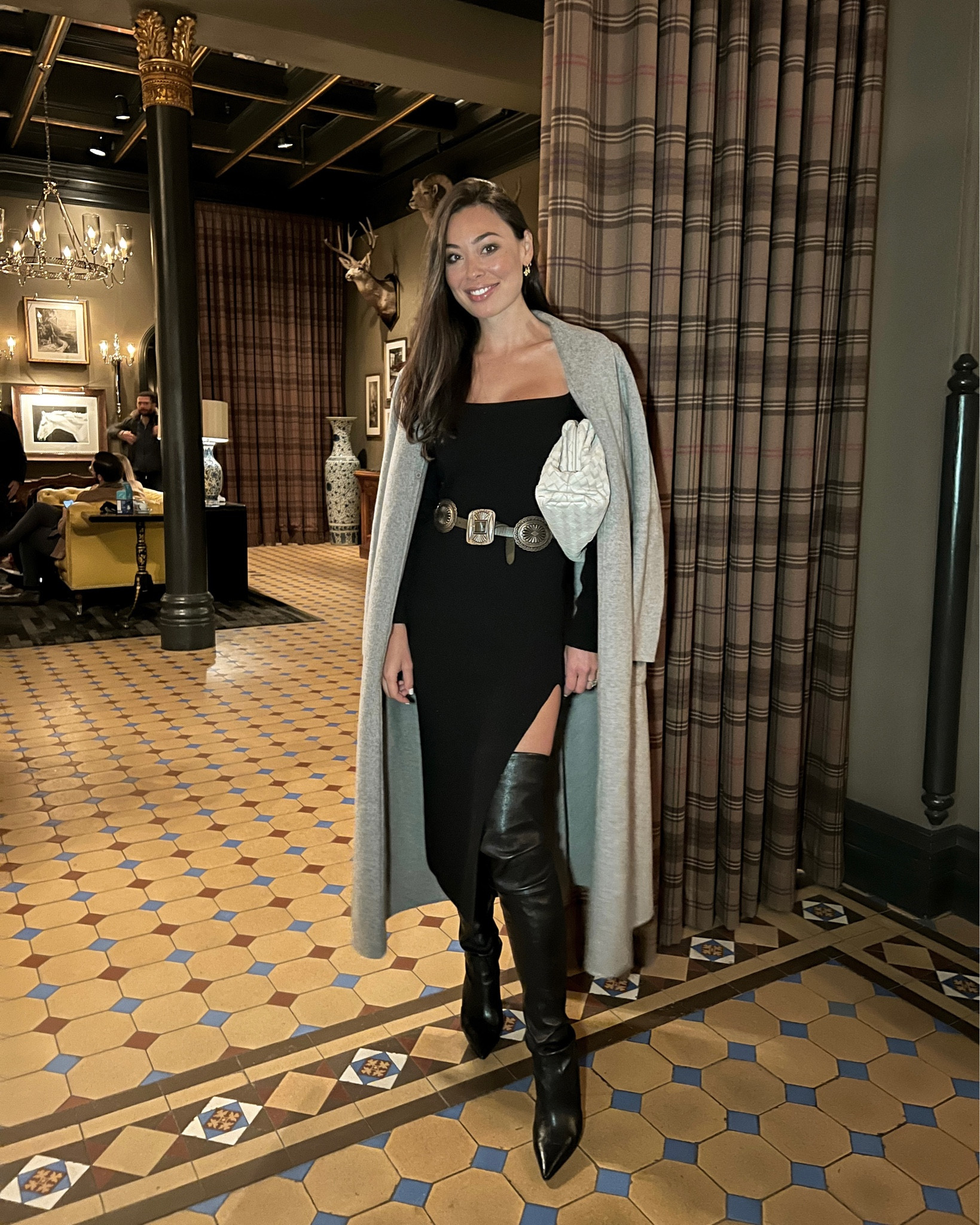Kat Jamieson wears a black sweater knit dress, over the knee leather boots, a grey coat, western belt, and Bottega Veneta pouch clutch bag in Aspen. Winter style, date night, designer, chic, classic, neutrals. 

#LTKshoecrush #LTKitbag #LTKSeasonal