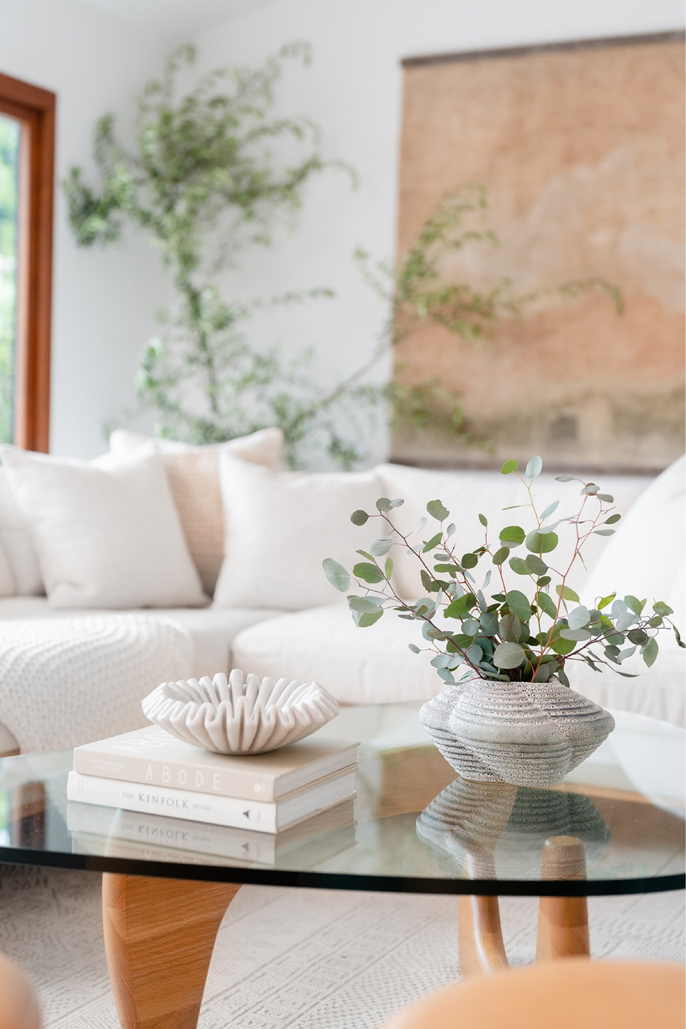 Living room with neutral and warm tones. Large wall art, coffee table, sofa, fluted bowl, throw pillows, area rug, vase, book, and throw blanket. 

Family room, living room style, living room decor, home decor, home finds, rug, large art, wall art, tapestry, silk tapestry. 

#LTKfamily #LTKhome #LTKstyletip