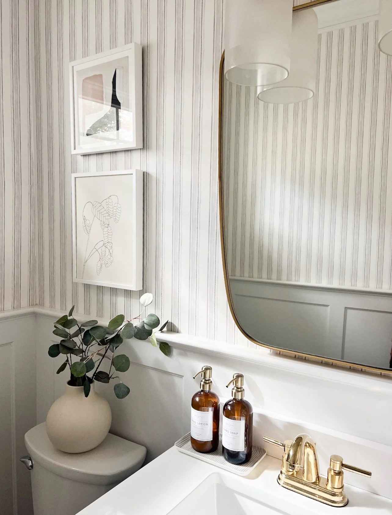 This bathroom has so many simple details that make it feel special. The striped wallpaper, brass mirror and faucet, framed art, and amber soap dispensers all work together without making the space feel too busy.

bathroom decor, powder room ideas, striped wallpaper, brass bathroom fixtures, bathroom mirror, soap dispenser, bathroom styling, small bathroom ideas, neutral home decor, girlonthehudson

#LTKHome #LTKSeasonal #LTKmorningroutine