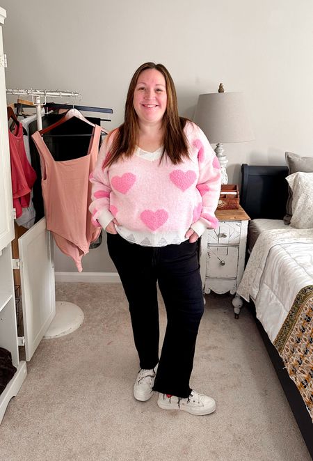 Plus size petite Valentine's/Galentine's outfit idea! Jess is wearing a pink heart print sweater from Arula in a size B, a pair of Madewell jeans in a size 33P, and a super cute pair of Converse sneakers with heart details! 

#LTKSeasonal #LTKcurves #LTKFind