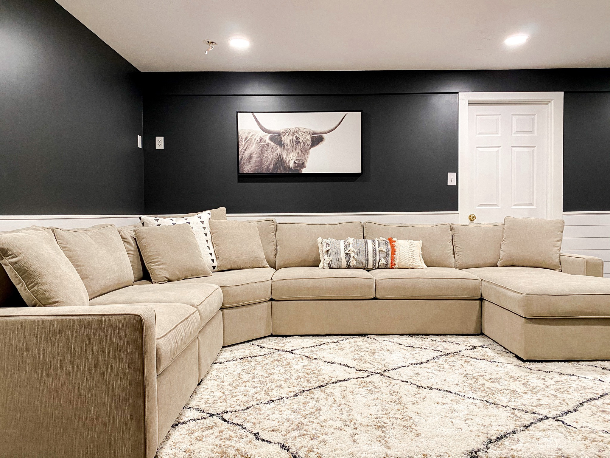 Living room. Modern basement. Radley sectional. Sectional sofa. Sectional couch. Family room. Shiplap. Benjamin Moore Wrought Iron. Elliptical. Basement renovation.

#LTKfamily #LTKhome #LTKSeasonal