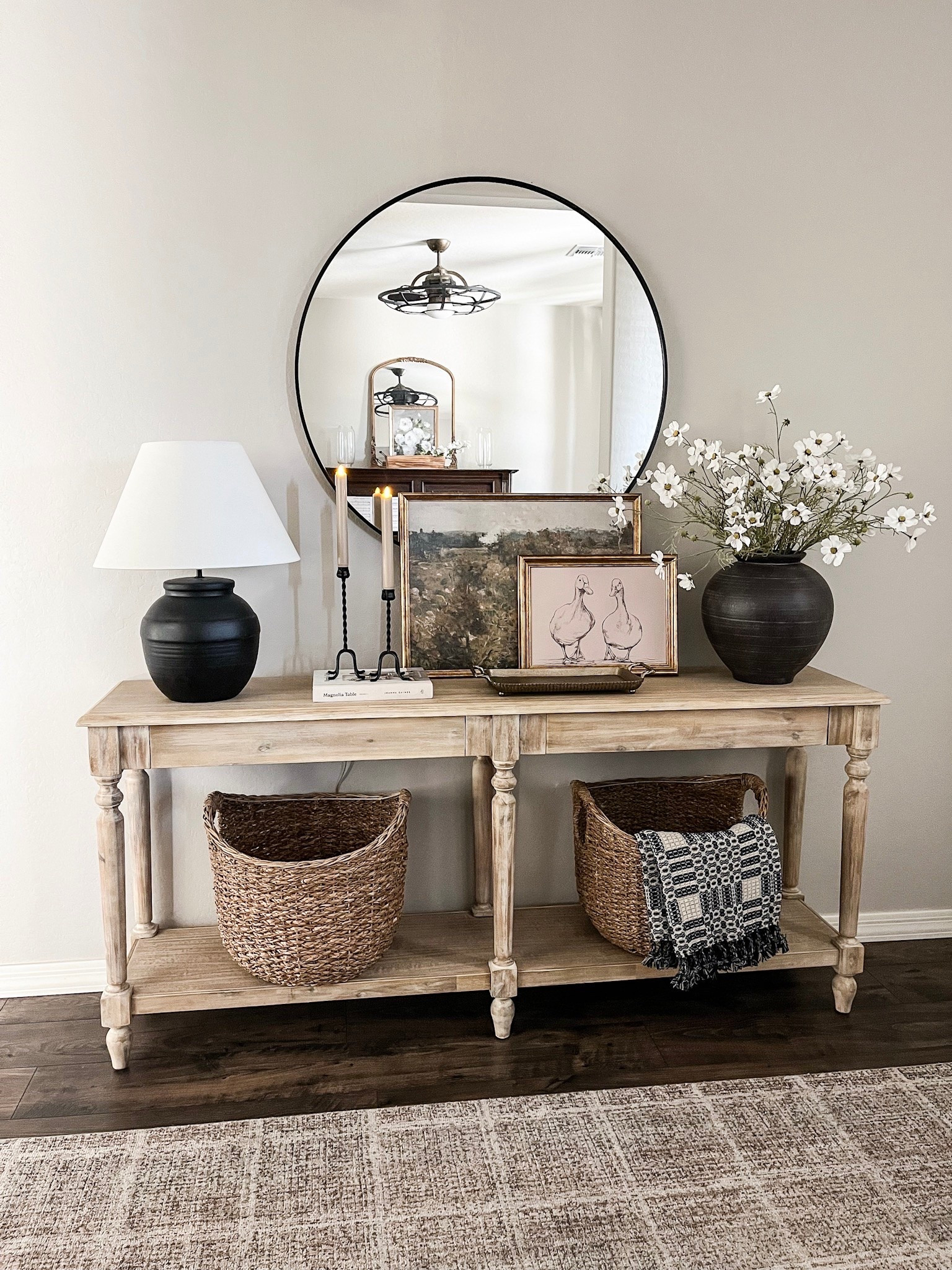 Simple summer entryway styling!  Summer florals, iron candle holders, beautiful artwork including a landscape scene and more adorable ducks to go with the ones on my porch. Baskets and a beautiful navy and neutral summer throw to complete the look!

#homedecor #entrywaystyling #entrywaydecor #summerdecor

#LTKSeasonal #LTKSaleAlert #LTKHome