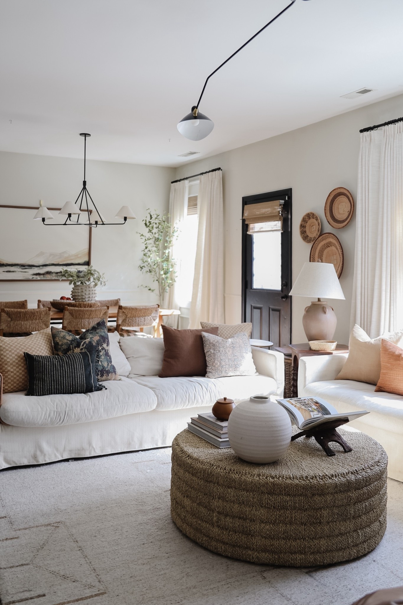 Neutral cozy living room, white slipcover style sofa, large round woven coffee table 

#LTKHome
