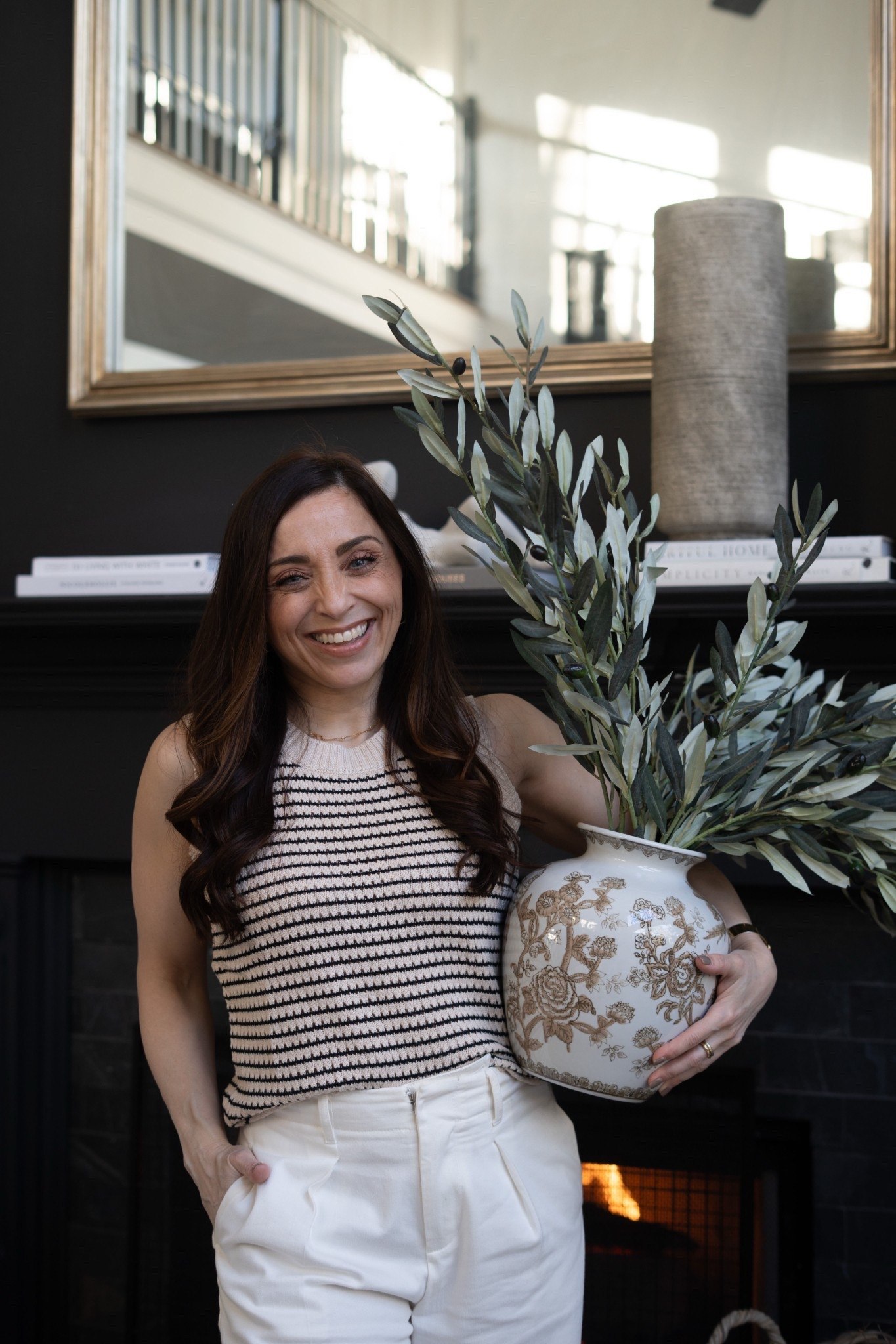 I cannot get over how gorgeous these olive stems look in this detailed ceramic vase. The soft greenery adds life to the fireplace mantel while the neutral pattern keeps the whole space feeling calm, refined, and perfectly layered. This is exactly the kind of modern organic living room styling I love.

#LTKSpringSale #LTKHome #LTKSeasonal