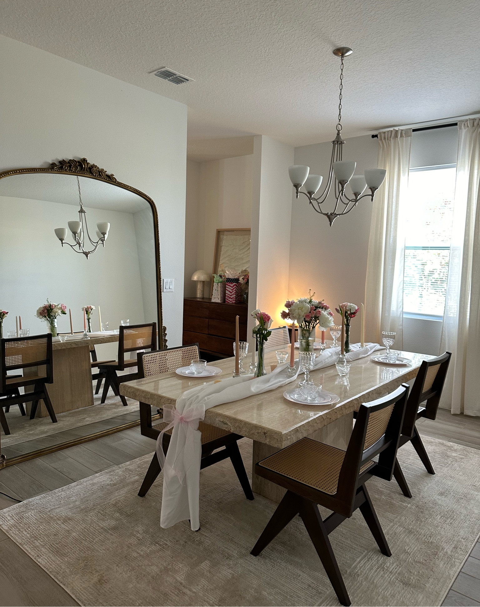 Parisian / mid century modern dining room inspo with Anthropologie mirror and travertine table #home #homedecor #homedecorinspo #diningroom #diningroomdecor #anthropologiemirror 