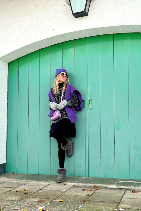 Purple Look. Fashion Blogger Girl by Style Blog Heartfelt Hunt. Girl with blond hair wearing a purple beanie, purple sweatshirt, funky sweater, Ray-Ban sunglasses, skirt, lilac mini bag and Ugg boots. #colorfuloutfit #colorfulstyle #colorfulfashion #colorfullooks #fashionfun #cutefalloutfit #fallfashion2022 #falllookbook #fitcheck #dailylooks #dailylookbook #contentcreator #microinfluencer #discoverunder20k