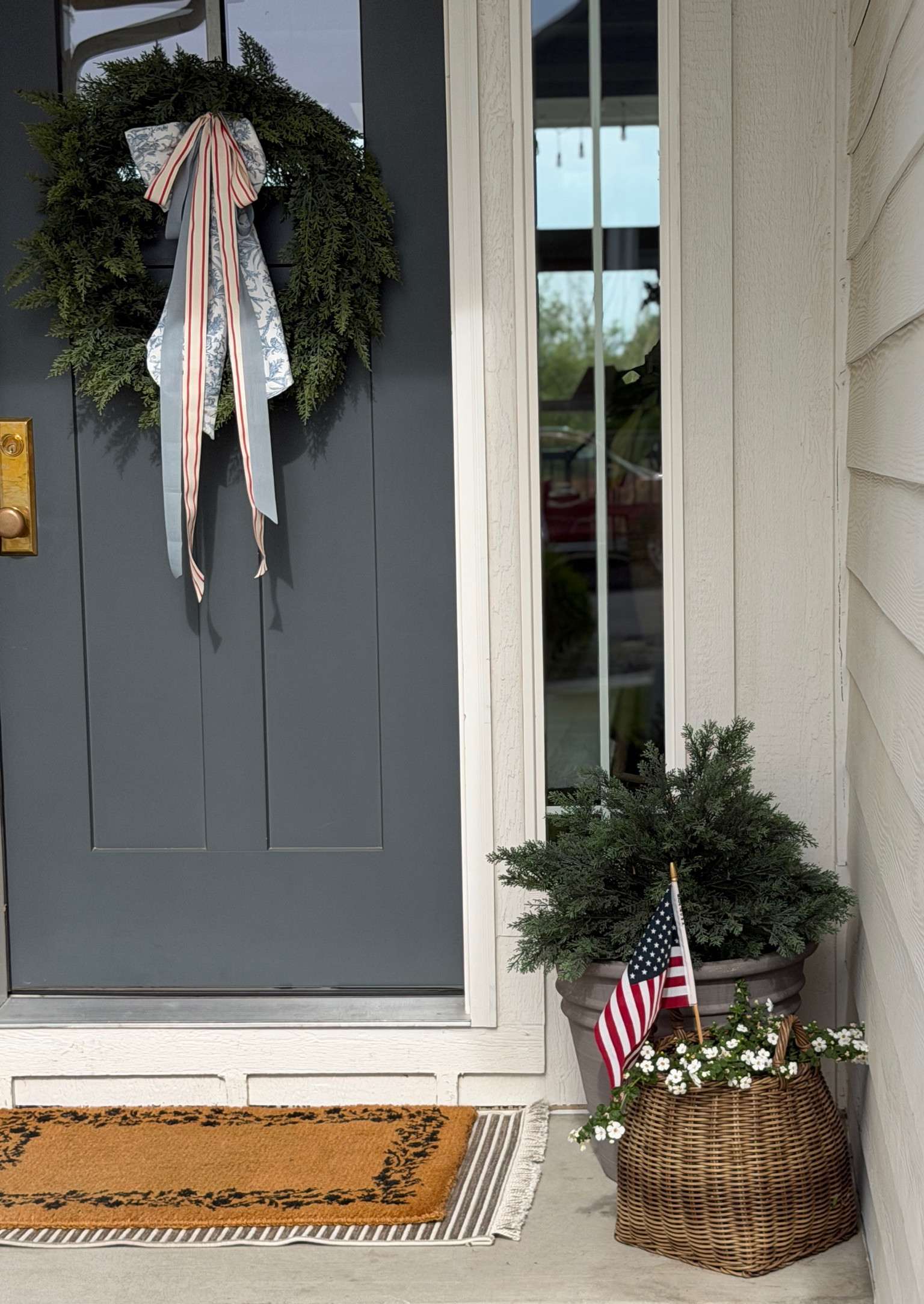 Our front door is ready for the fourth! I love pairing different ribbons together to make a big beautiful bow. 

home decor, fourth of july decor, plants
