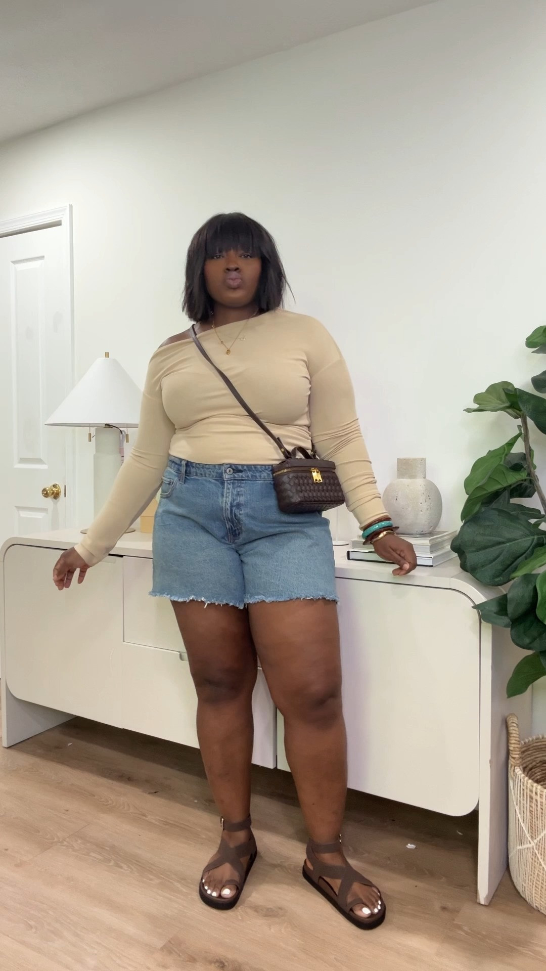 The long sleeve top is lightweight enough to keep you comfortable without feeling too hot, the denim shorts are easy everyday staples, and the sandals? Comfortable enough for walking around ALL day. 

Perfect if you’re looking for:
summer travel outfits, casual vacation outfits, denim shorts outfit ideas, neutral summer fashion, comfy airport outfits, plus size vacation style, everyday summer looks, and effortless capsule wardrobe pieces.  

 #LTKootd #LTKSeasonal #LTKMidsize