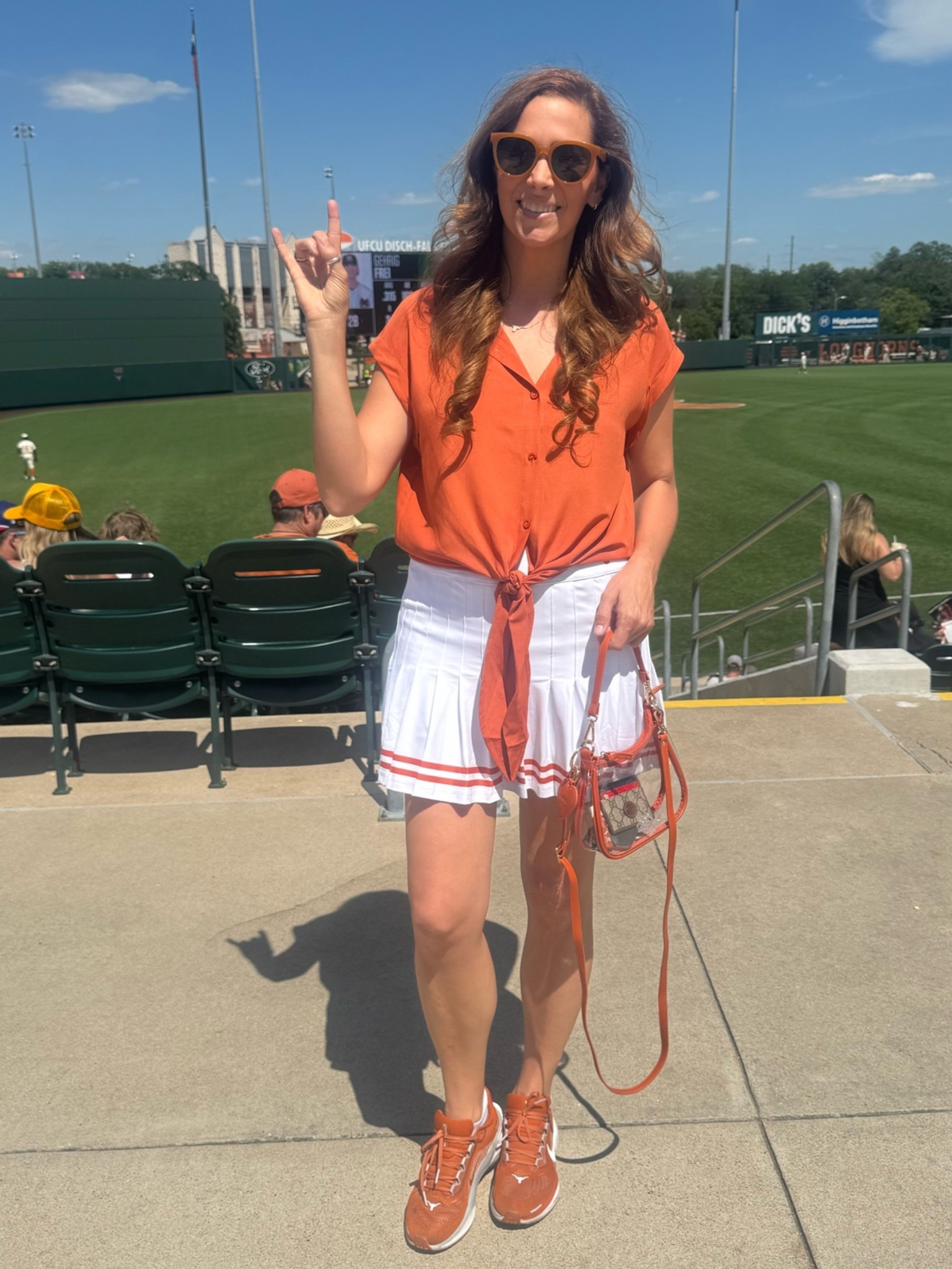 Cheered on Texas baseball this weekend in a $19 burnt orange tie front button down shirt with the $66 Gwen skirt by smith & Quinn. With the Clara Desden clear purse and Nike sneakers! Hook em!

#LTKdayinmylife #LTKActive #LTKWorkwear