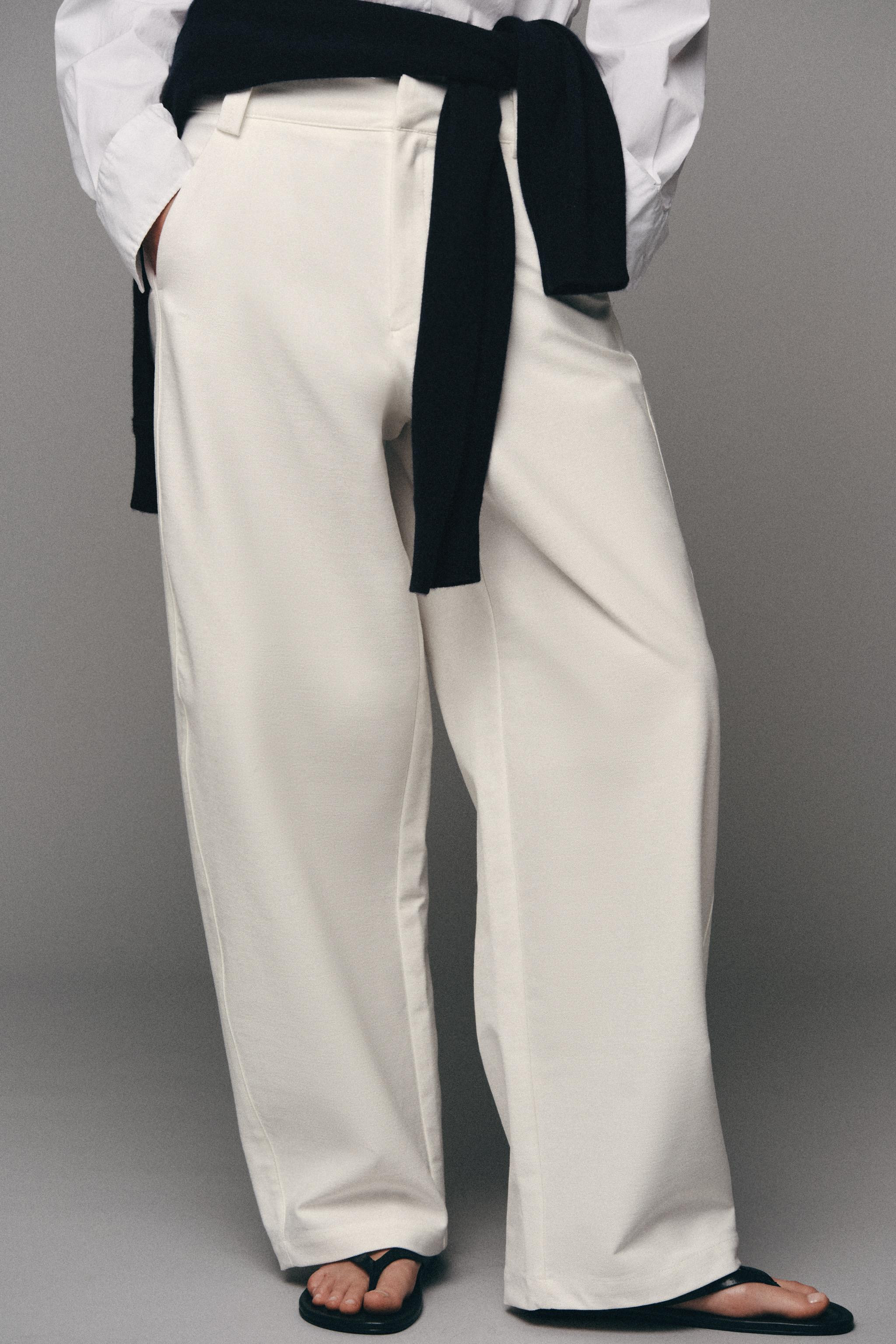 Mid-waist trousers featuring front pockets and rear patch pockets. Loose fit, tapered towards the... | Zara UK