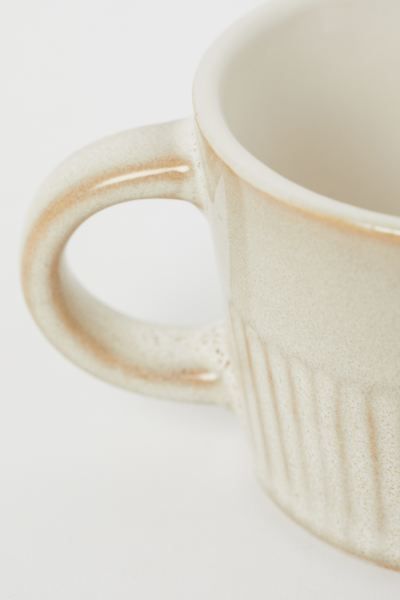 Glazed ceramic espresso cup with a handle and fluted lower section. Height 2 in. Diameter 2 1/2 i... | H&M (US + CA)