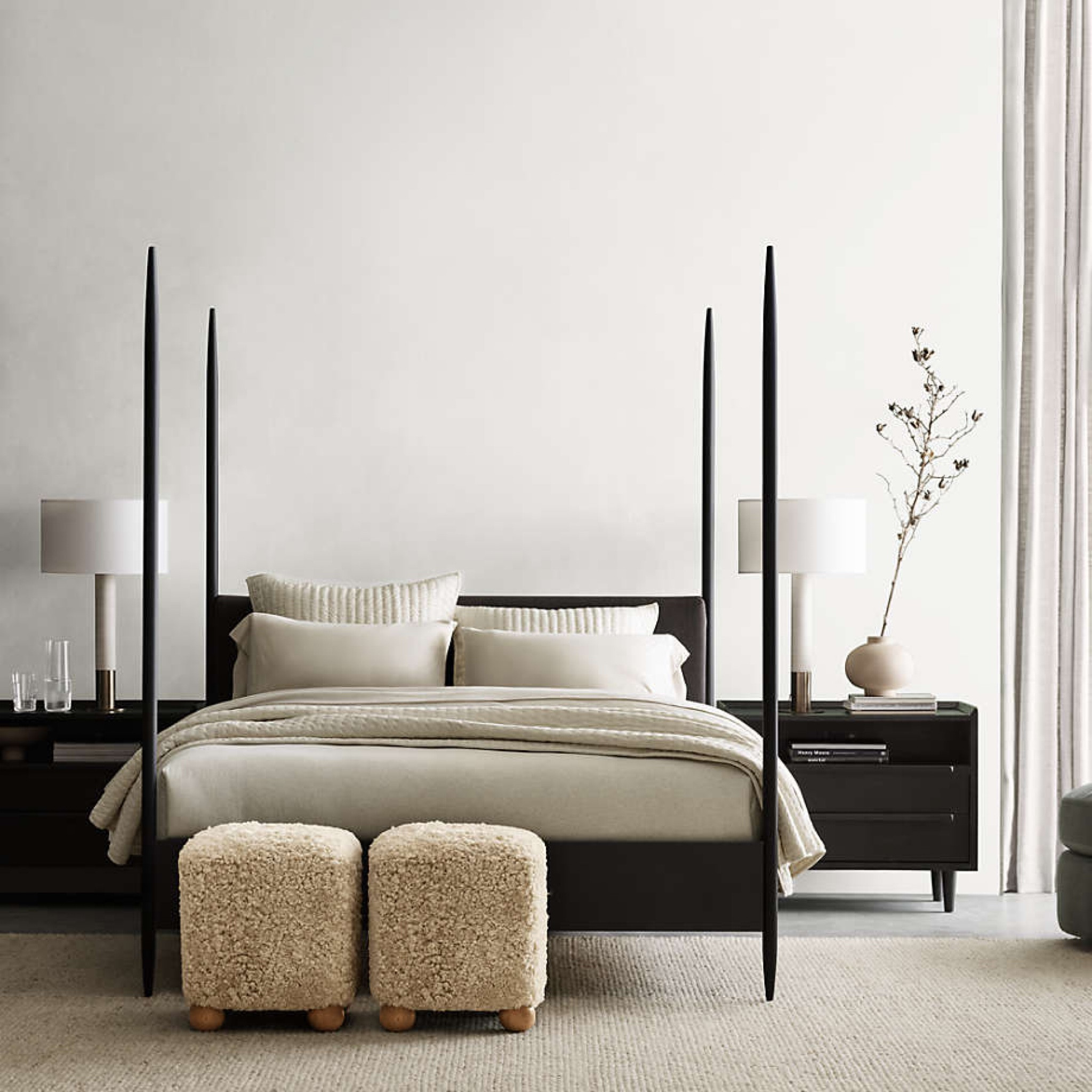 Not your grandmas poster bed! Have and love!! Queen size ON SALE now! Streamlined steel posts rise high and tapered, finished in black with a fine sand-like texture. The minimalist headboard is neatly wrapped in a black fabric with the nubby feel of linen. With its low platform and high-rise posts, the exclusive Dearborn bed plays with proportions in a uniquely modern way.
