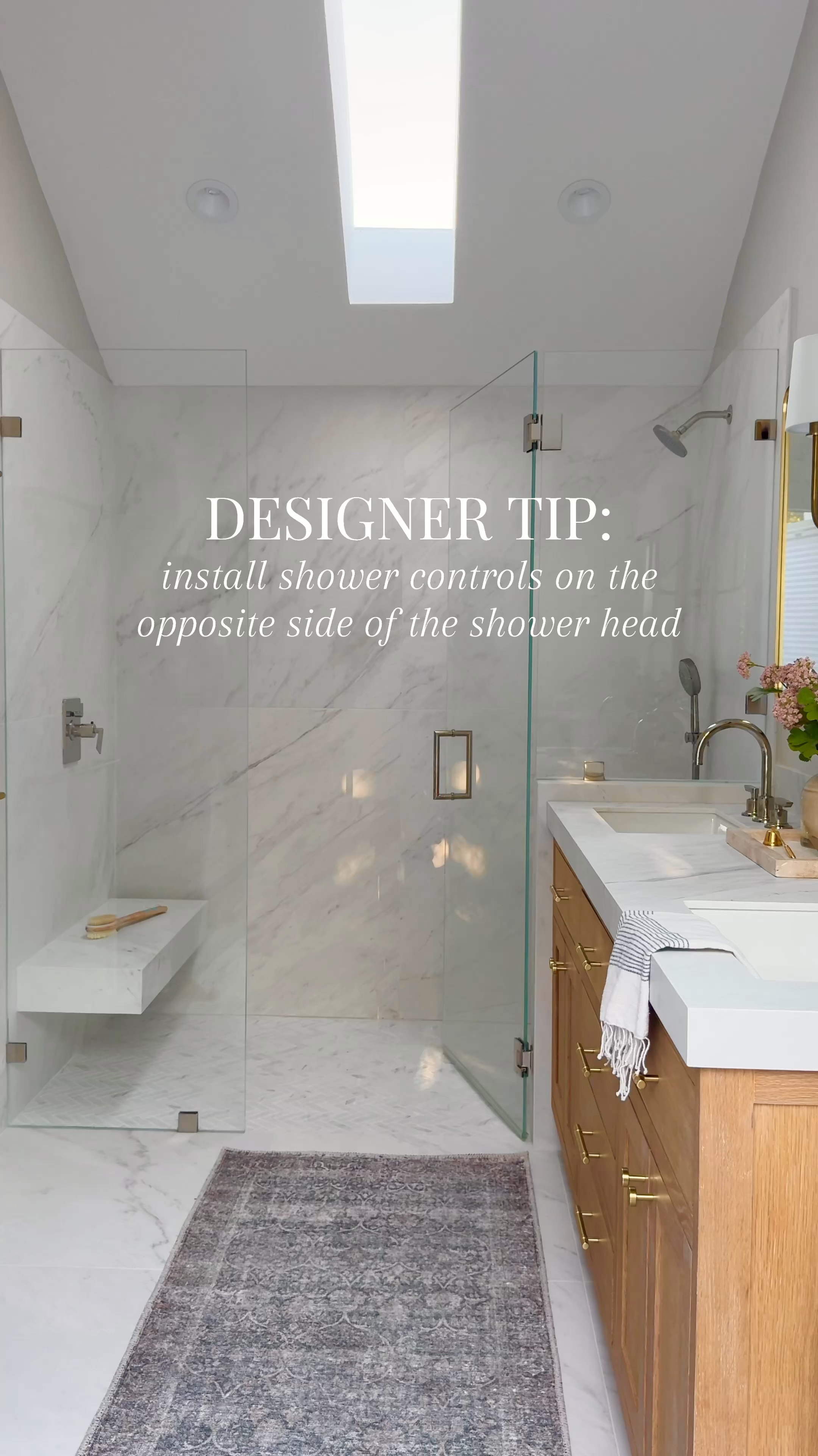This is a great design tip to remember next time you are doing a bathroom remodel. Polish nickel faucet, chrome, faucet, shower, glass door, pink flowers brass hardware, travertine tray, striped towel, wood vanity, brass double sconce medicine cabinet, rectangle, mirror, brass mirror, black mirror, marble tile, vintage rug, washable rug. Fluted reeded wood  

#LTKHome #LTKFindsUnder100 #LTKSaleAlert