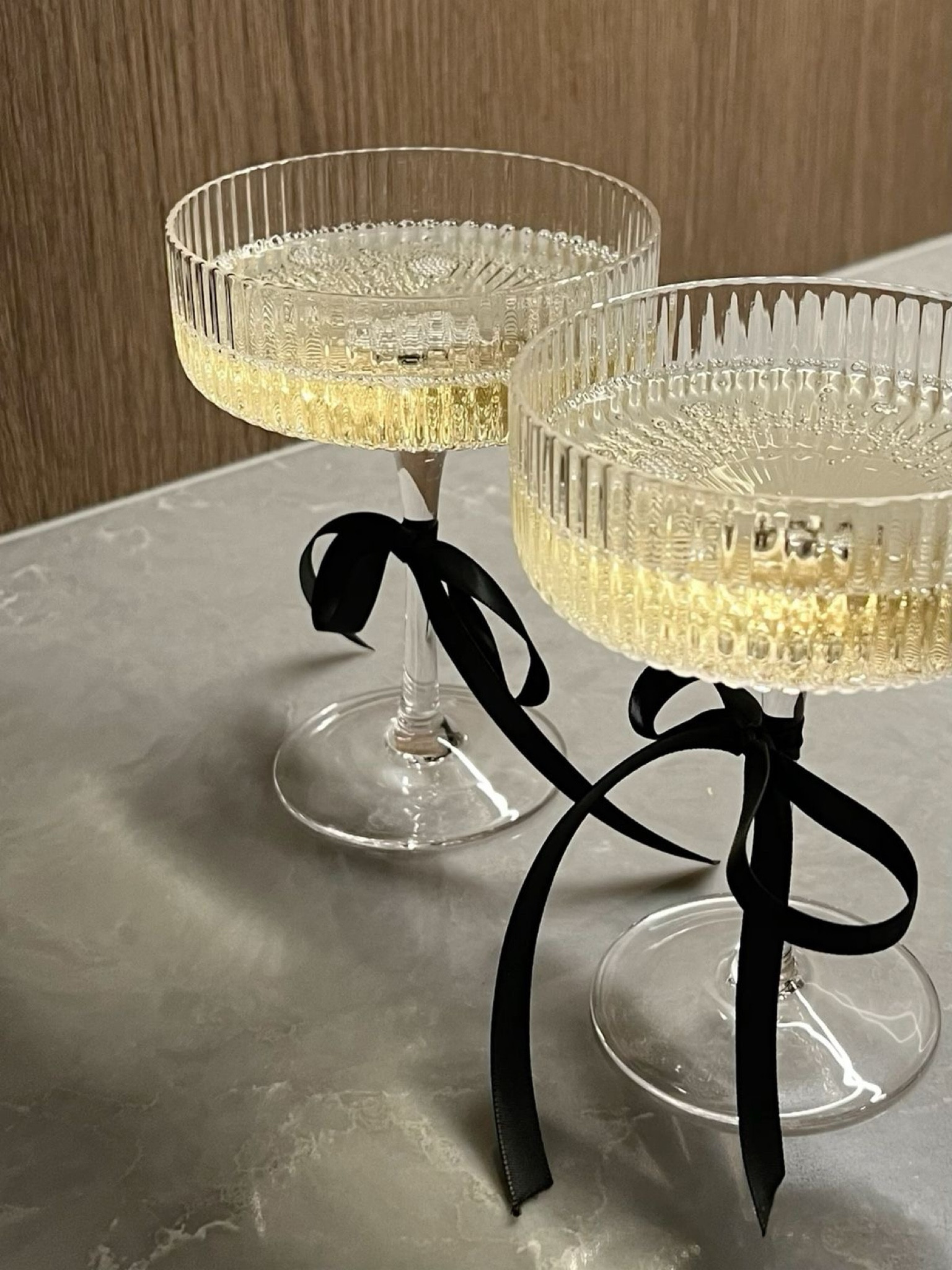 New Year's Eve champagne tower, champagne coupes with bows
Nye prep!! 🥂

Make a champagne tower with coupe glasses tied with black bows for a chic touch.
The prettiest decor before even pouring champagne!
Champagne tower,
Coupe glasses, champagne tower,
Black satin ribbon, champagne glasses, Champagne glasses with ribbon bows, Elegant champagne tower,
Gold platter champagne display,
CB2 coupe glass tower,
Stylish party champagne setup, Luxury champagne tower ideas, Modern champagne tower design,
Satin ribbon stemware decor, Black and gold champagne setup, Wedding champagne tower display, Holiday champagne tower centerpiece, Sophisticated coupe glass tower, New Year's Eve, New Year's party, new years hosting

#LTKFindsUnder100 #LTKSeasonal #LTKGiftGuide