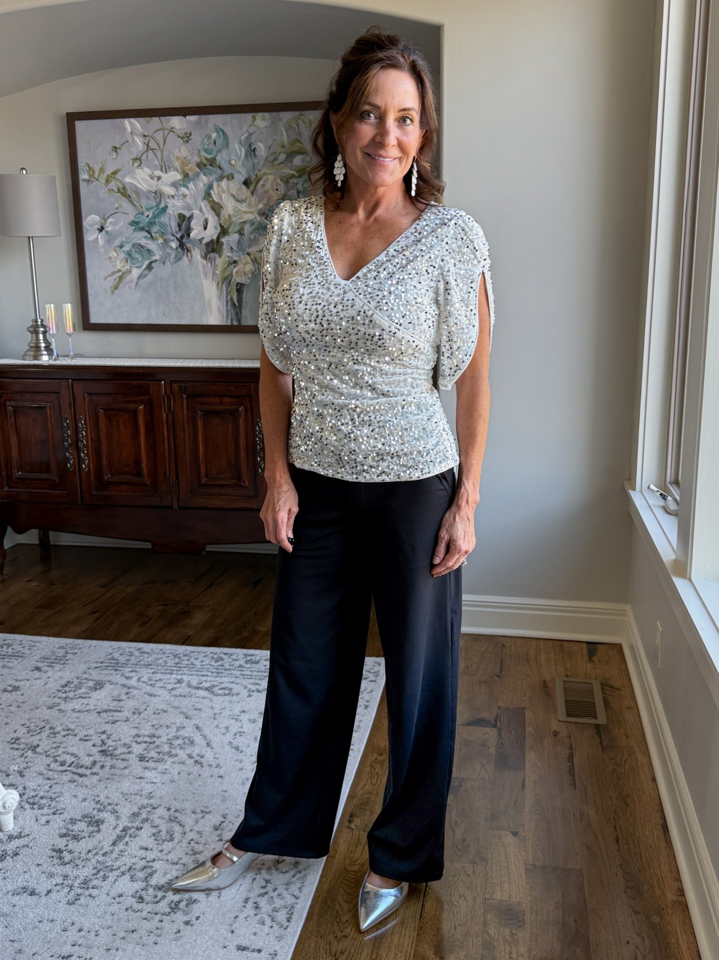 This stretch sequin top paired with flowy black trousers is my go-to for nights that call for sparkle without sacrificing ease. Flattering, forgiving, and perfect for women 40+ who want to shine—and still feel comfortable all evening.

#LTKFindsUnder50