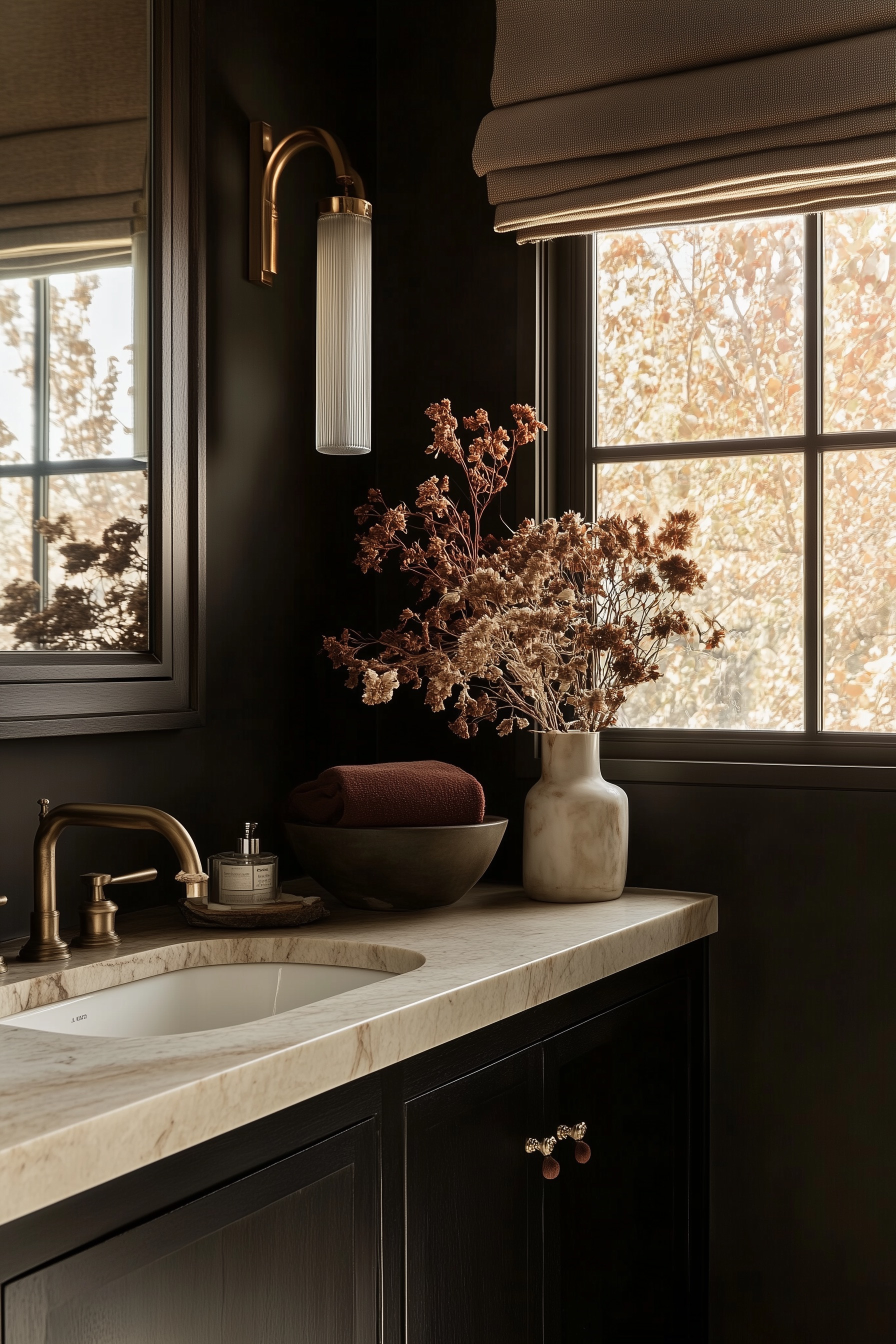 this moody bathroom with charcoal walls, matte black vanity, marble countertop, and warm brass fixtures. Dried florals and a Roman shade add cozy, modern rustic vibes. If you love dark paint and natural stone, you’ll get spa-like style in a small space too. Save this for bathroom decor ideas, powder room makeover inspiration, and fall home design. 

 #LTKHome #LTKFindsUnder100 #LTKStyleTip