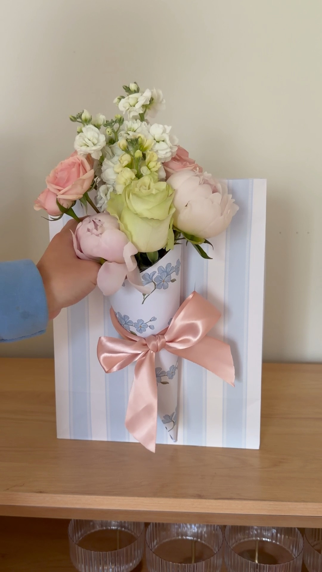 Save this idea for Mother’s Day gifting and beyond! I cannot get enough fresh flowers these days and this is the perfect way to gift them! 

I make two slits in the gift bag and thread ribbon through them and then use that to attach a paper cone (made using 5in x 5in square paper—I glued two pieces of craft paper together to make it double sided) and insert your fave flowers! I wrap bottom of the flowers with a wet paper towel and foil over that so they don’t wet the bag and they stay fresh! 

The best part is that the receiver of the gift can easily take the flowers out and put them in a vase or display them in the paper cone!

#LTKMothersDay #LTKmomlife #LTKSeasonal