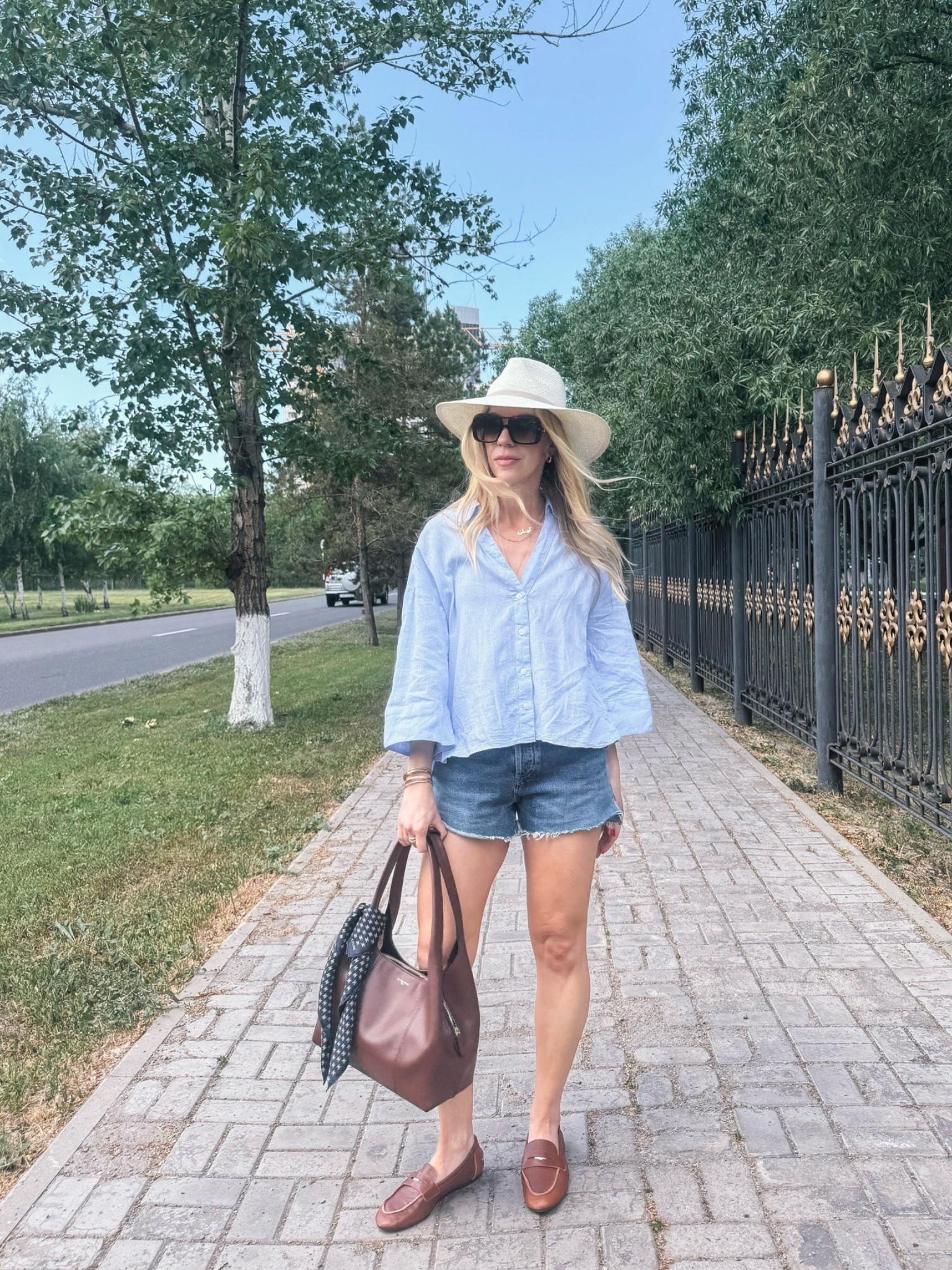 Casual summer outfit with oversized linen shirt, denim cutoff shorts, @Janessa Leone straw hat, @Zara leather loafers, Le Tanneur handbag (on sale 20% right now!)

#LTKSaleAlert #LTKSeasonal #LTKOver40