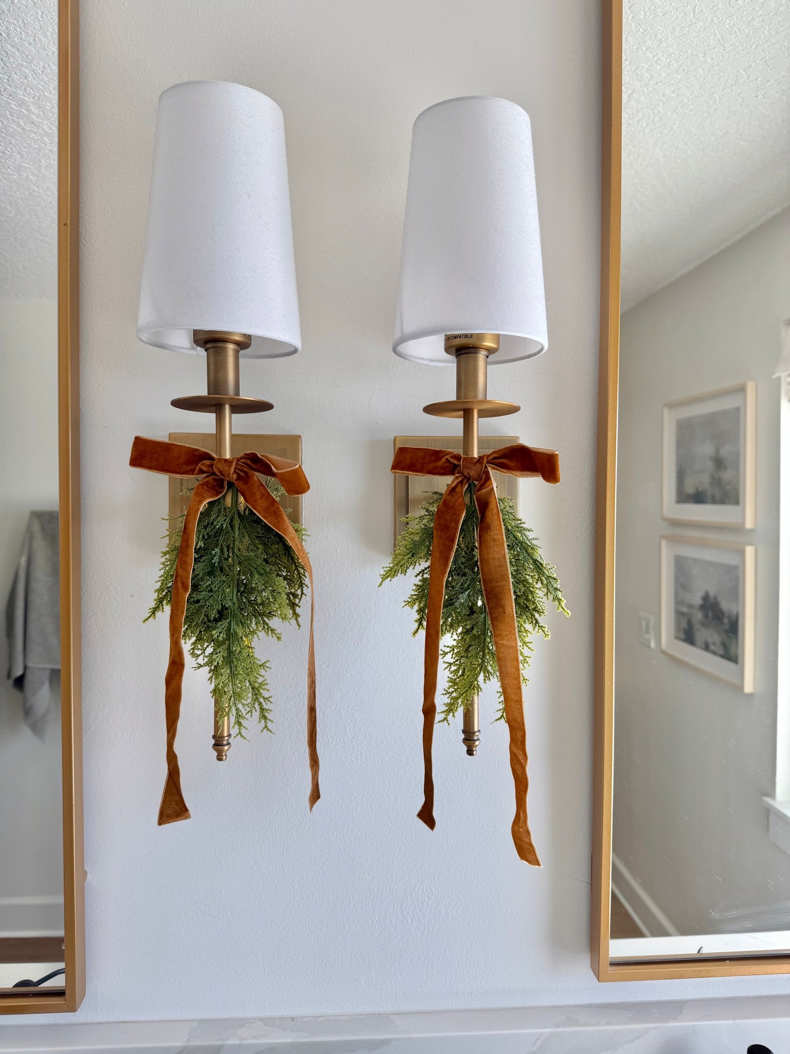 Inexpensive faux greenery swags for lighting 
Bathroom sconces 
Gold mirrors 
Art 

#LTKHome #LTKSaleAlert #LTKHoliday