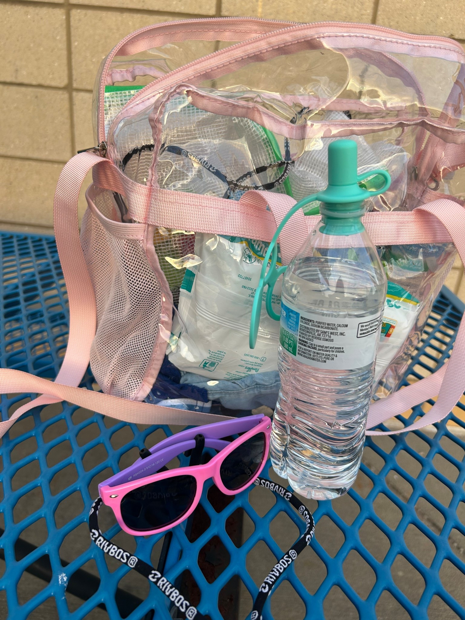 Things we have at the stadium coming in clutch. 
1) 12x12x6 clear bag with handles or a shoulder strap. Front pack and 2 water bottle pouches on the sides (comes in many color options). 
2) water bottle adaptor kid spout. Fits in any standard size bottle spout and has an attached cap. Helps minimize spills
3) kids sunglasses with a “necklace” strap. Idk what it is about this simple upgrade but it makes all the difference in our kids keeping up with their sunglasses 

#LTKSummerEdit #LTKKids #LTKFamily