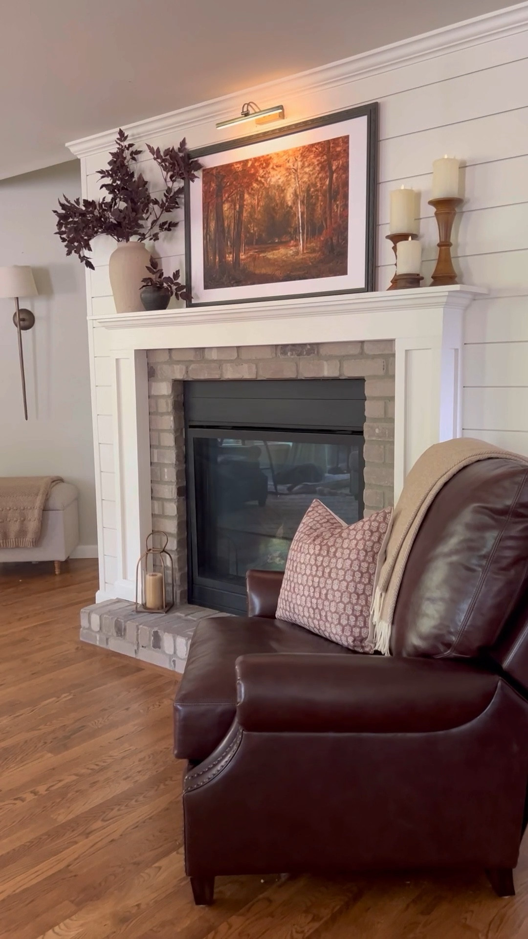 When styling my fireplace mantel for fall, I love to create a cozy and inviting focal point with a few key elements. I start by adding beautiful, fall-inspired artwork featuring moody, rust, and golden-colored trees. This sets the tone for a warm autumn vibe. To complement the artwork, I use deep burgundy-colored stems arranged in organic pottery, adding rich texture and a touch of nature.

Next, I bring in wooden candlesticks paired with flameless candles to create that soft, flickering glow—perfect for those cozy evenings. The combination of natural elements like wood, pottery, and vibrant fall colors brings warmth and a seasonal charm to the mantel, making it a stunning focal point in the room. This setup not only enhances the fall ambiance but also adds a layer of texture and depth, perfect for anyone looking to style their home for the season. 

#LTKSeasonal #LTKVideo #LTKHome