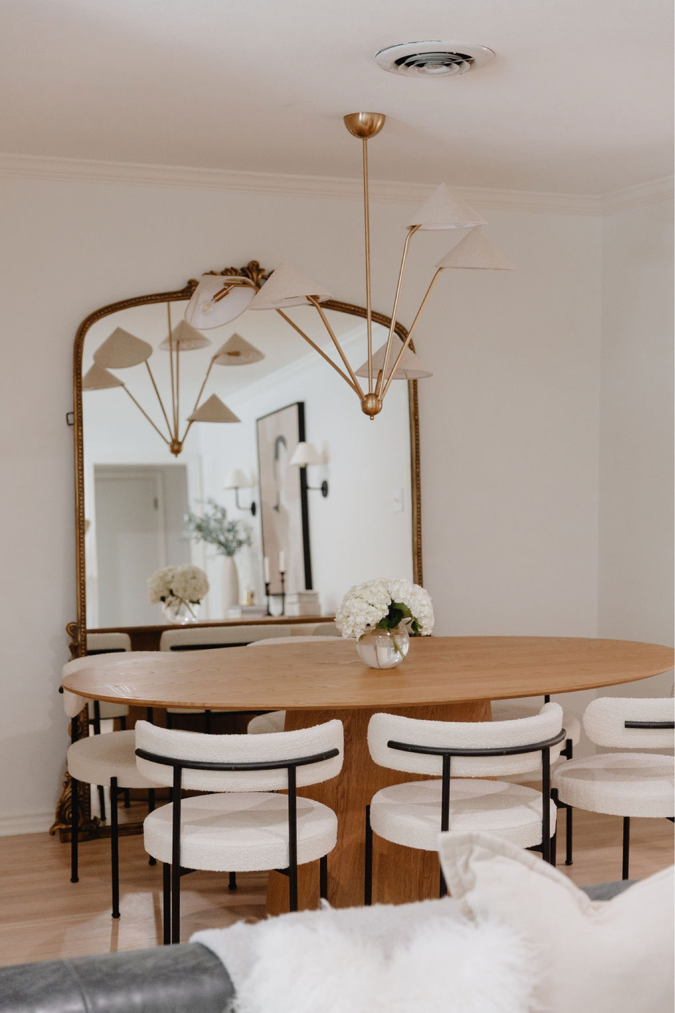 Dining room // home decor, dining room decor, dining room chairs, dining room table, candle holder, pampas grass, candleholders, dining table, chandelier, mirror, CB2, dried eucalyptus, vase, faux sheepskin, candles, table runner, Amazon home decor, modern home decor, modern decor, tablescape, modern home decor, neutral home decor, dining room, dining room decor, living room, living room decor 
