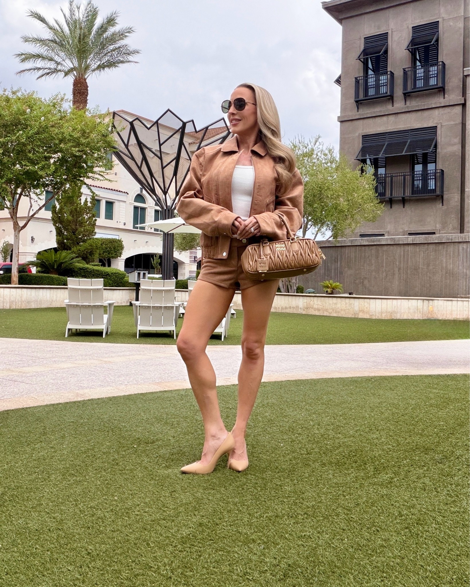 Fall outfit idea: monochrome brown outfit - brown suede bomber jacket and brown suede shorts on major sale so get them while you can ($26!), runs TTS. Caramel Miu Miu leather bag, nude pumps and aviators obv to go with the bomber jacket ✈️

#LTKSeasonal #LTKSaleAlert #LTKootd