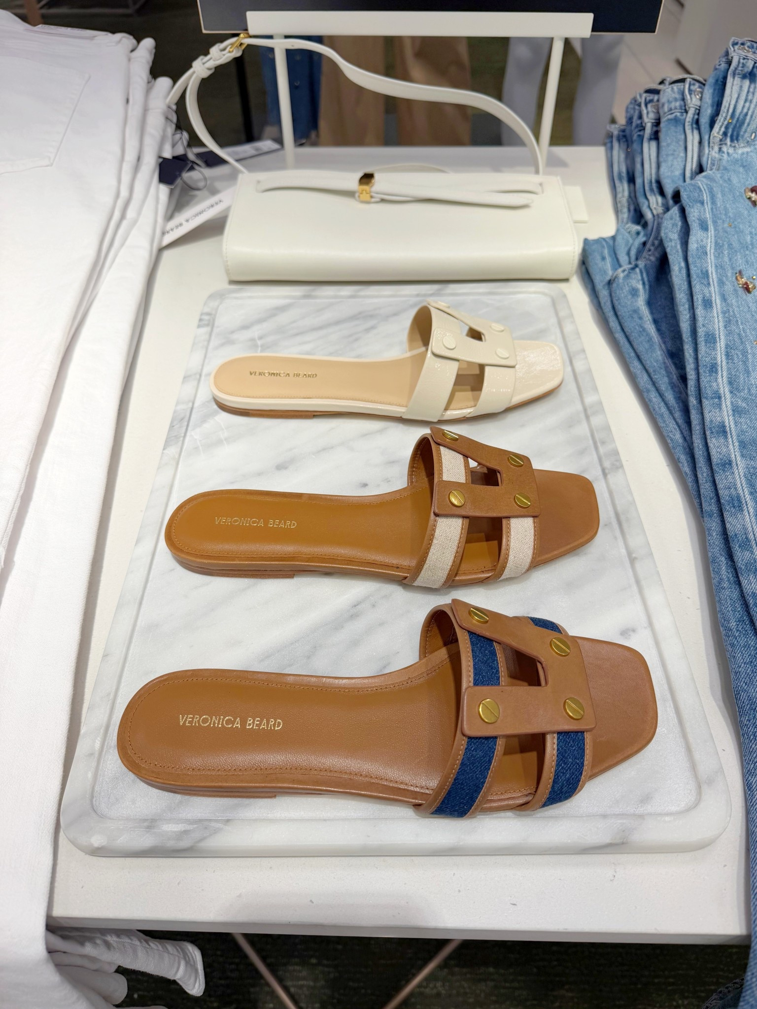 Loving these Veronica Beard accessories for spring and summer outfits! These slide sandals are absolutely gorgeous and I especially love the two tone versions. And this white clutch bag is perfect for date night outfits and special occasions like wedding guest outfits. 

#LTKSeasonal #LTKootd #LTKOver40