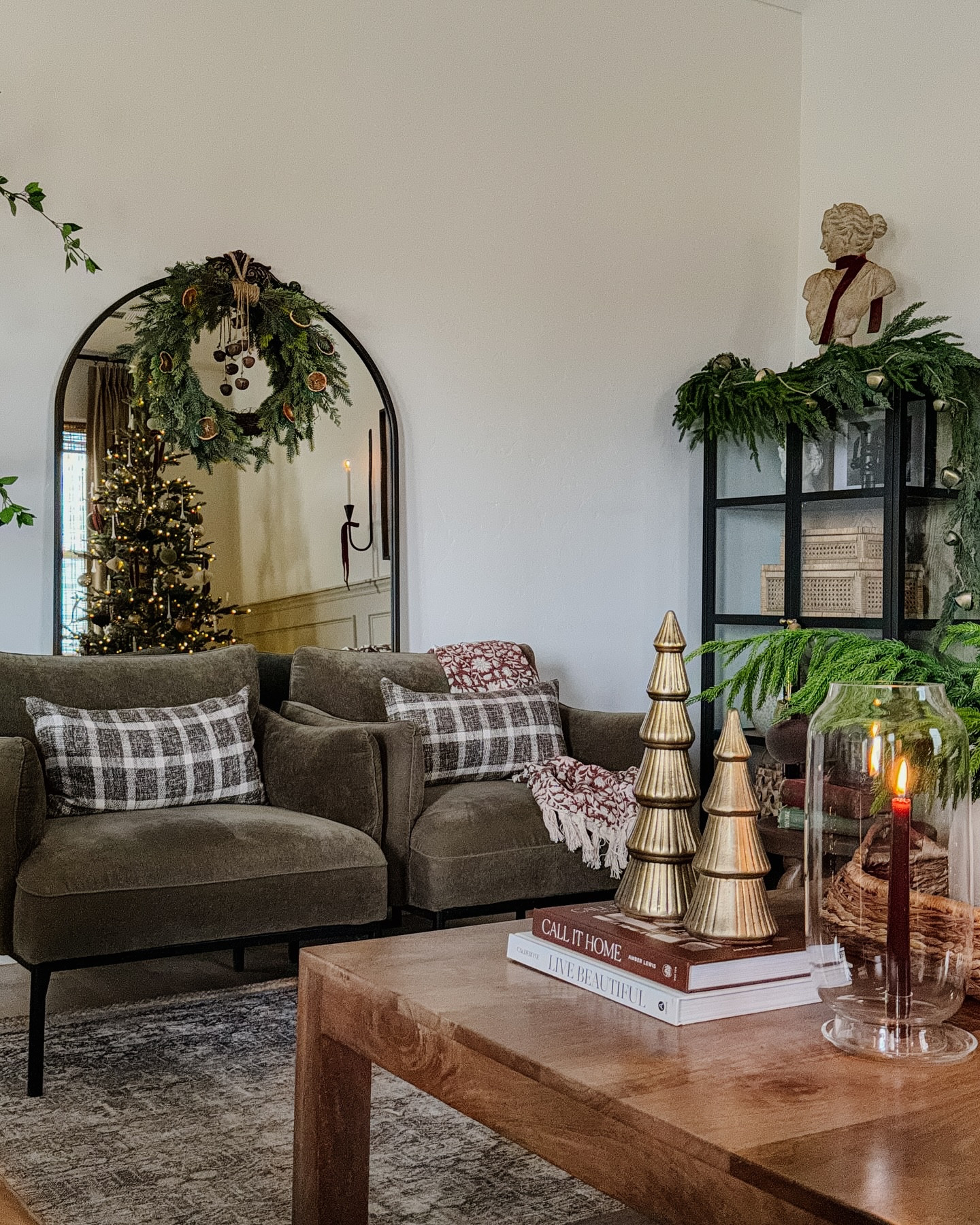 Christmas, living room, holiday, home decor, pre-lit Christmas tree, Living room inspo, custom curtains, pinch pleat curtains, floor to ceiling curtains, neutral sofa, beige sofa, west elm penn chair, green accent chair, vintage pillows, Turkish pillows, boucle pillow, shady lady tree, faux tree, greenery, Walmart floor lamp, woven table tray, square wooden coffee table, wall sconce, tapered candle holder, citrus tree, throw pillows, floor length mirror, arch mirror, Target home decor, affordable home, black cabinet, studio McGee cabinet, round glass coffee table, target accent table, vintage inspired rug, vintage milking stool, foot stool#LTKVideo

#LTKHoliday #LTKHome #LTKStyleTip