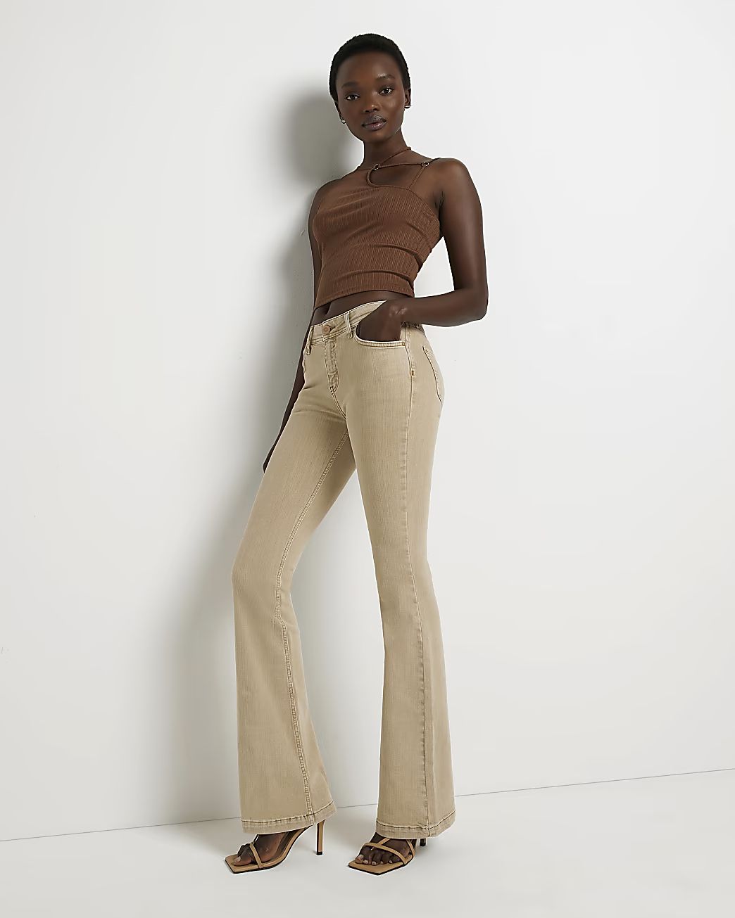River Island Womens Beige mid rise flare jeans | River Island (US)