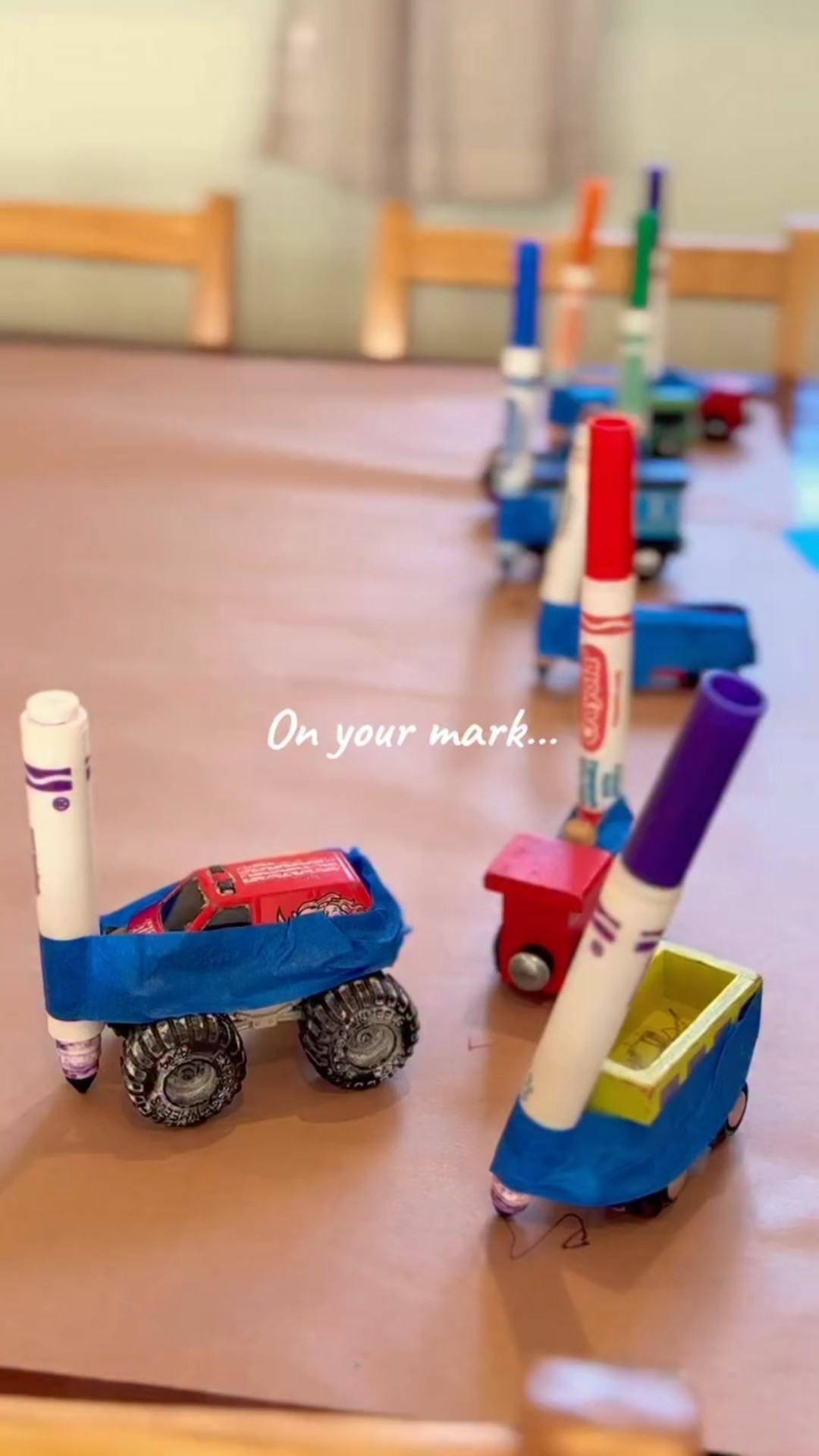 We turned the floor into a racetrack, taped markers onto cars, and let early writing look exactly like racing for once.

Racing builds hand strength, control, and coordination. They’re experimenting with pressure, direction, and cause-and-effect while staying fully engaged. Writing doesn’t have to be calm to be meaningful.

If your kid resists sitting to “practice,” try attaching the marker to something that already wants to move. Same skill building. Way more fun.